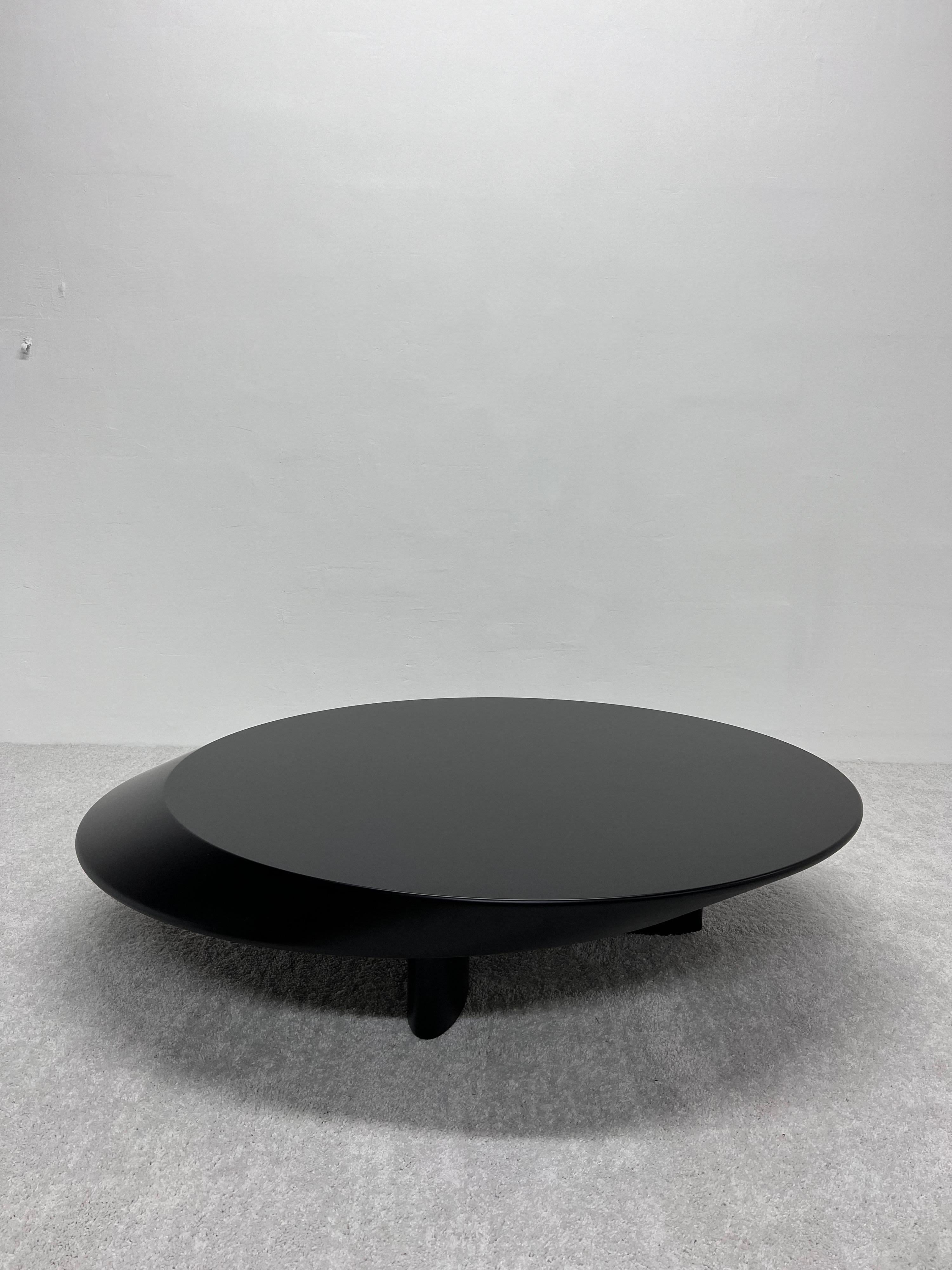 Black lacquer Accordo coffee table designed by Charlotte Perriand for Cassina.

Low table designed by Charlotte Perriand in 1985. Relaunched by Cassina in 2009. Manufactured by Cassina in Italy. This low table, with its audacious sculptural look,