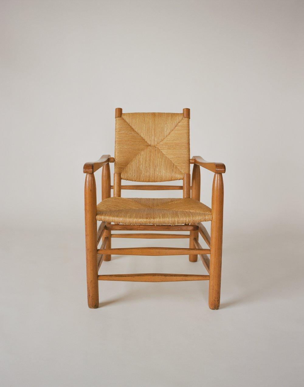 Questo design è un adattamento di Charlotte Perriand di uno dei suoi precedenti progetti di poltrone più rustiche del 1935. La rivisitazione dei lavori precedenti faceva parte di uno sforzo per creare una nuova gamma di mobili in legno a prezzi