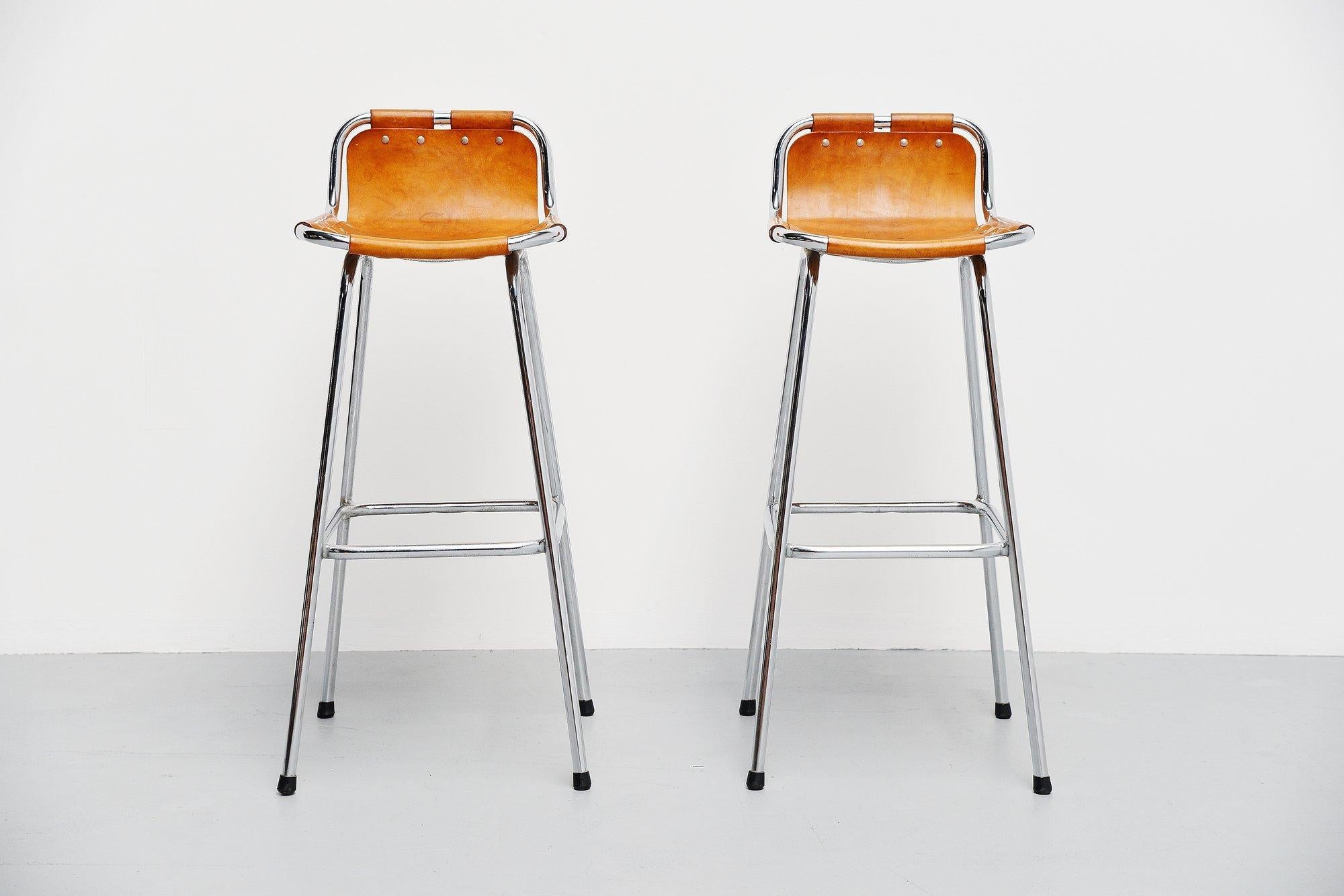 This is for a nice pair of bar stools used by Charlotte Perriand for the ski resort she designed in Les Arcs, France 1960. The stools have a chrome-plated tubular metal frame and natural leather seats. These or for sure one of the nicest stools you