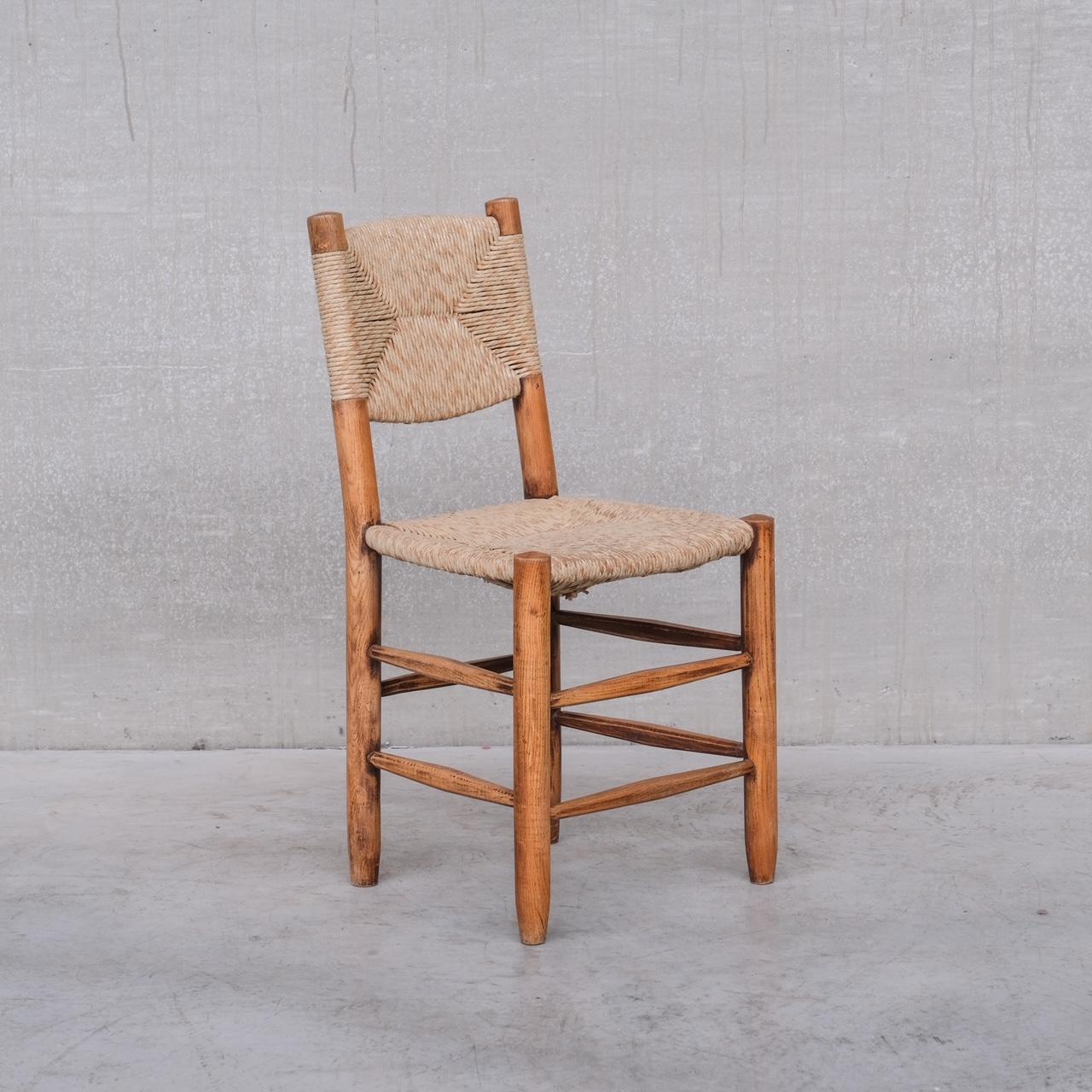 A set of seven 'Bauche' model 19 dining chairs. 

France, c1960s. 

By esteemed French designer, Charlotte Perriand.

For Steph Simon. 

Price is for the seven. The set is assembled so there is slight variations in colour of the cord etc. We have