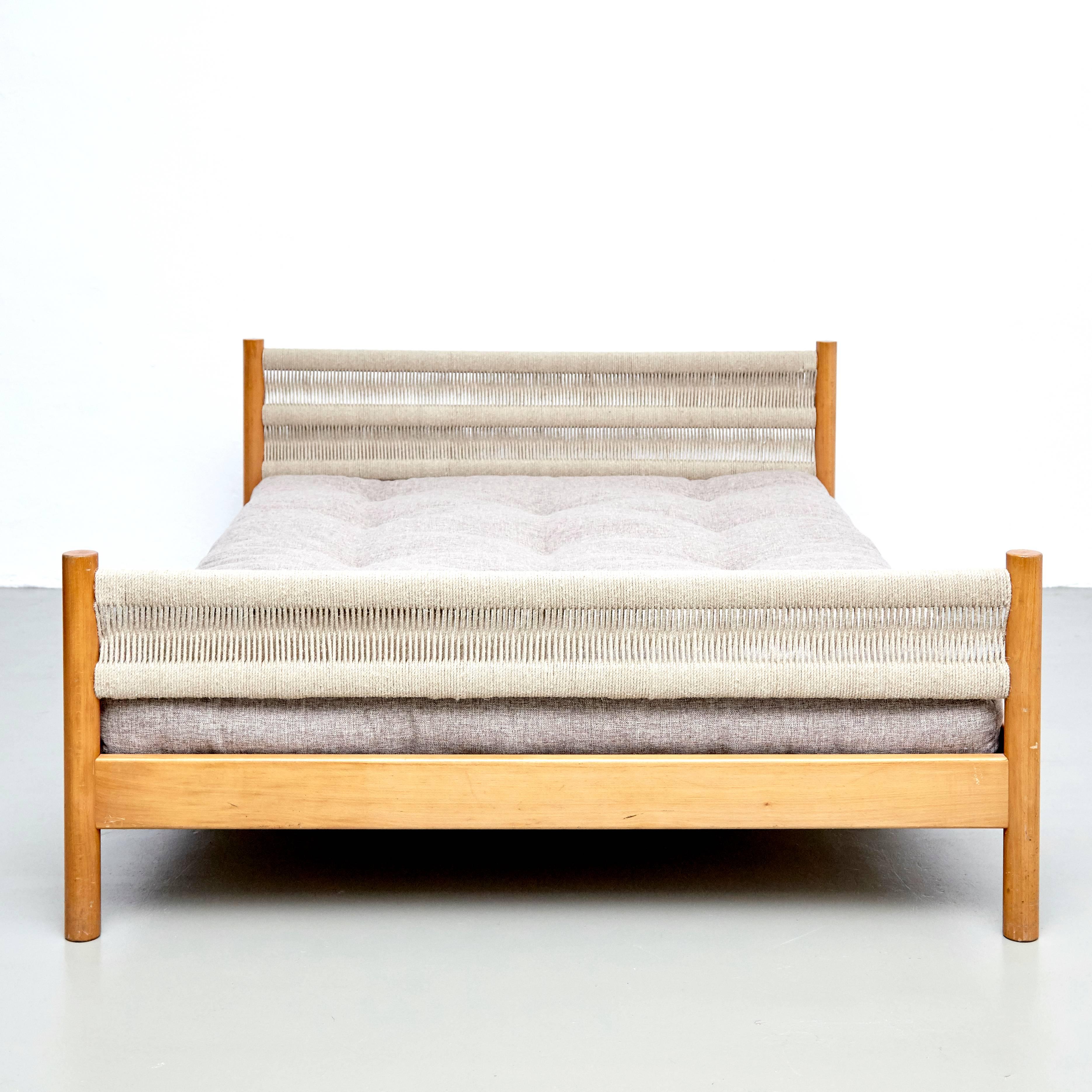 Bed designed by Charlotte Perriand for Meribel, circa 1960.
Manufactured in France.

Pinewood and rope, new upholstery.

In good original condition with minor wear consistent with age and use, preserving a beautiful patina.

Charlotte
