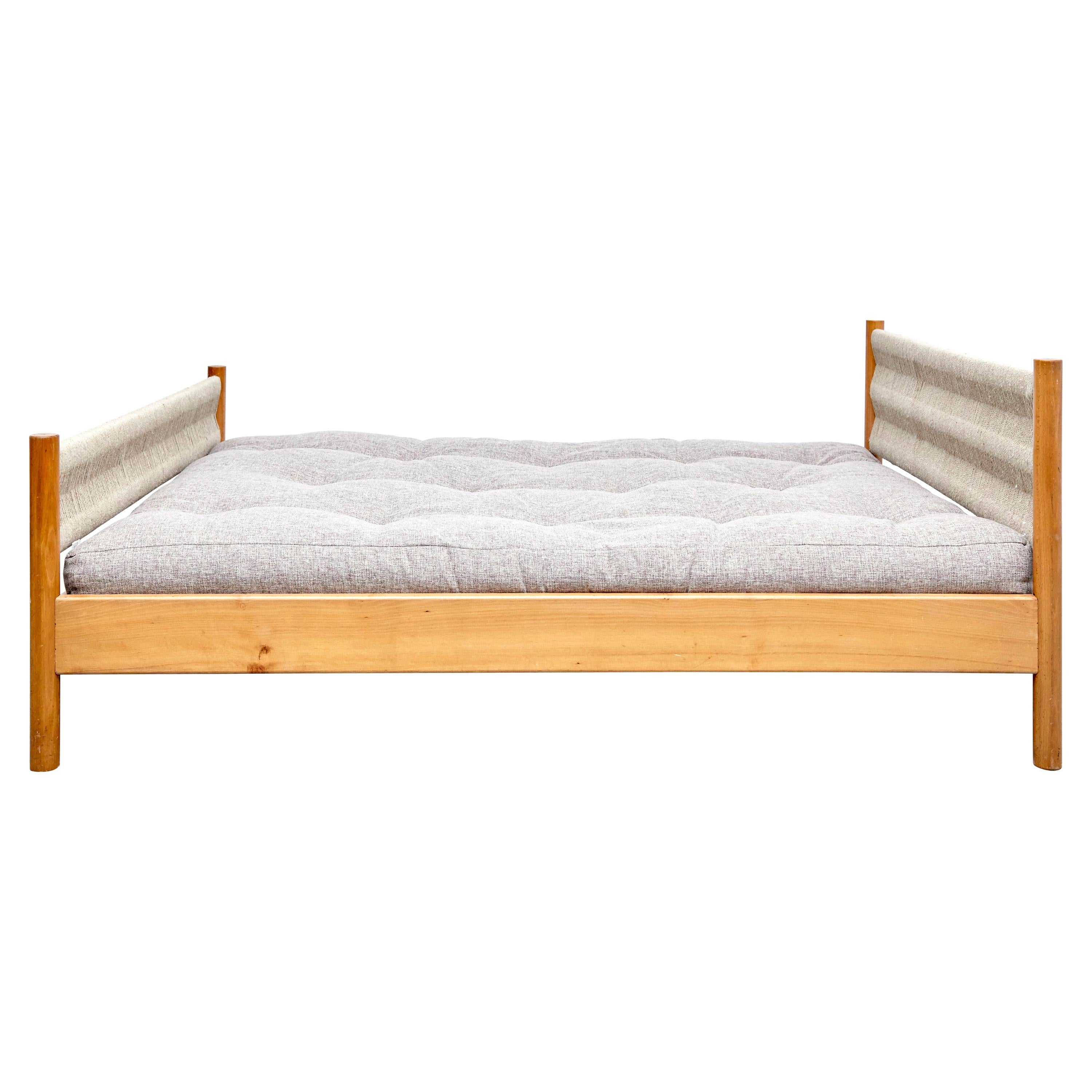 Bed designed by Charlotte Perriand for Meribel, circa 1960.
Manufactured in France.

Pinewood and rope, Matress not included.

In good original condition with minor wear consistent with age and use, preserving a beautiful patina.

Charlotte Perriand