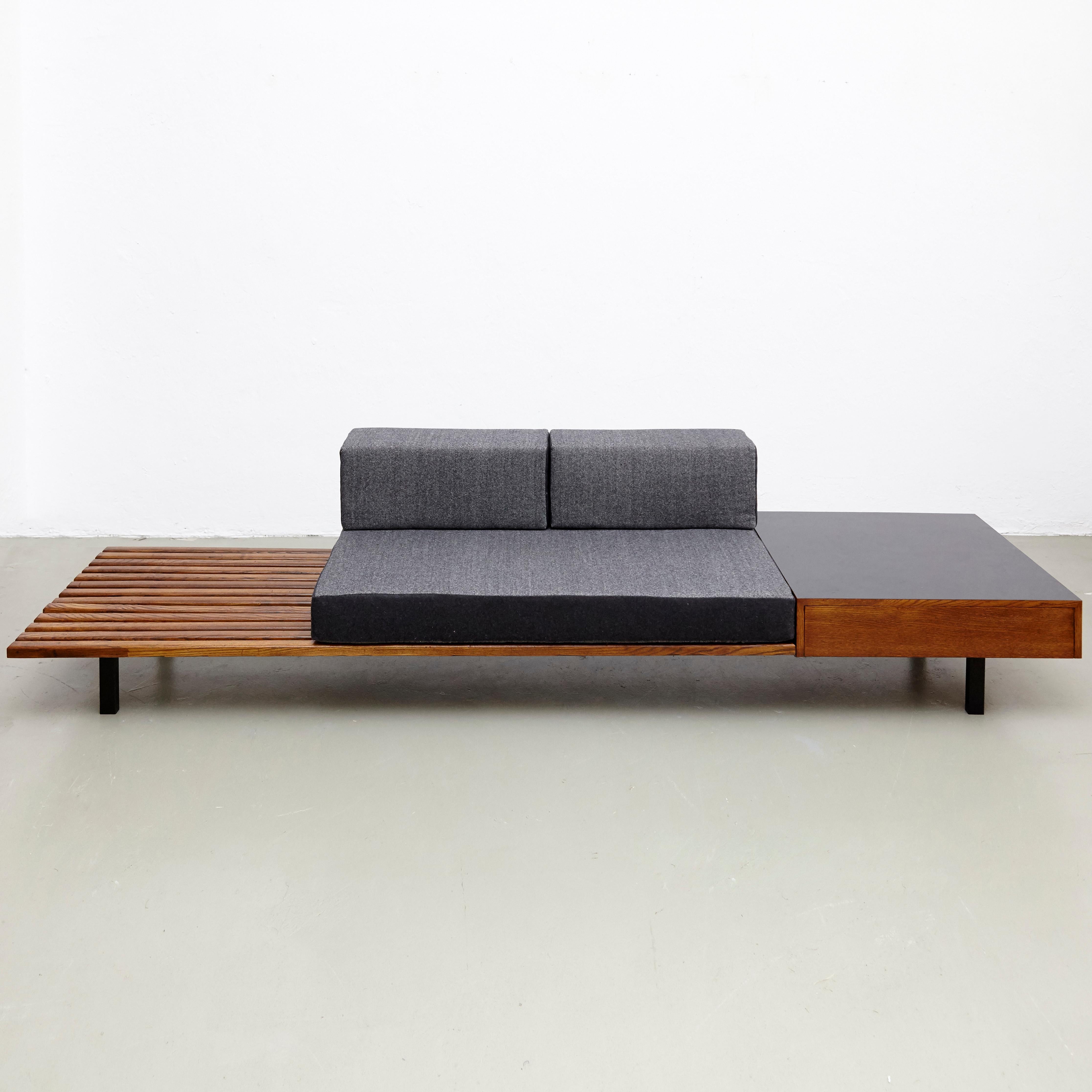 Bench with side table and drawer, from Cite Cansado, Mauritania, designed by Charlotte Perriand.
Mahogany wood, oak, plastic laminated covered wood, lacquered metal and fabric.

In good original condition, with minor wear consistent with age and