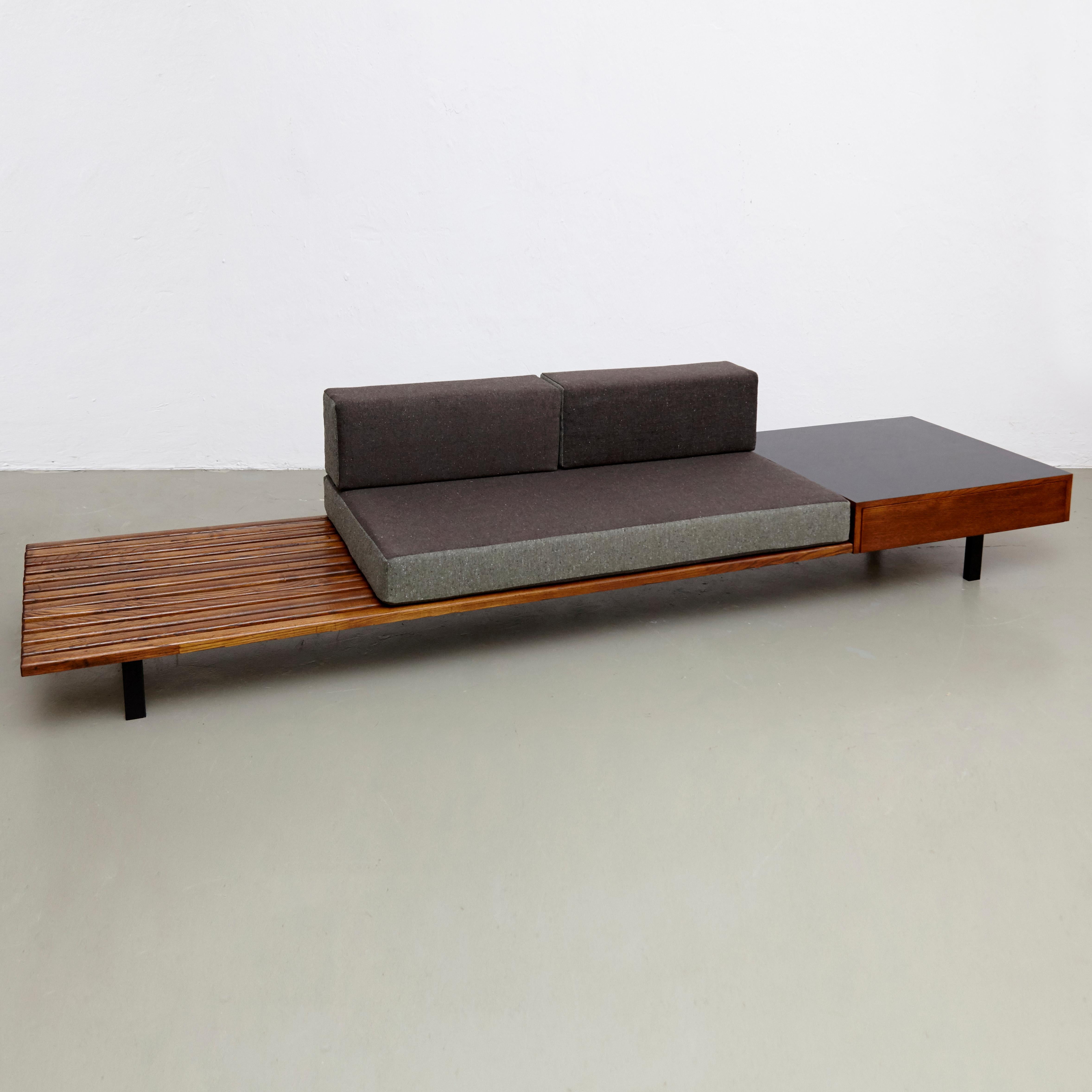 Bench with side table and drawer, from Cite Cansado, Mauritania, designed by Charlotte Perriand.
Mahogany wood, oak, formica laminated covered wood, lacquered metal and fabric.

In good original condition, with minor wear consistent with age and