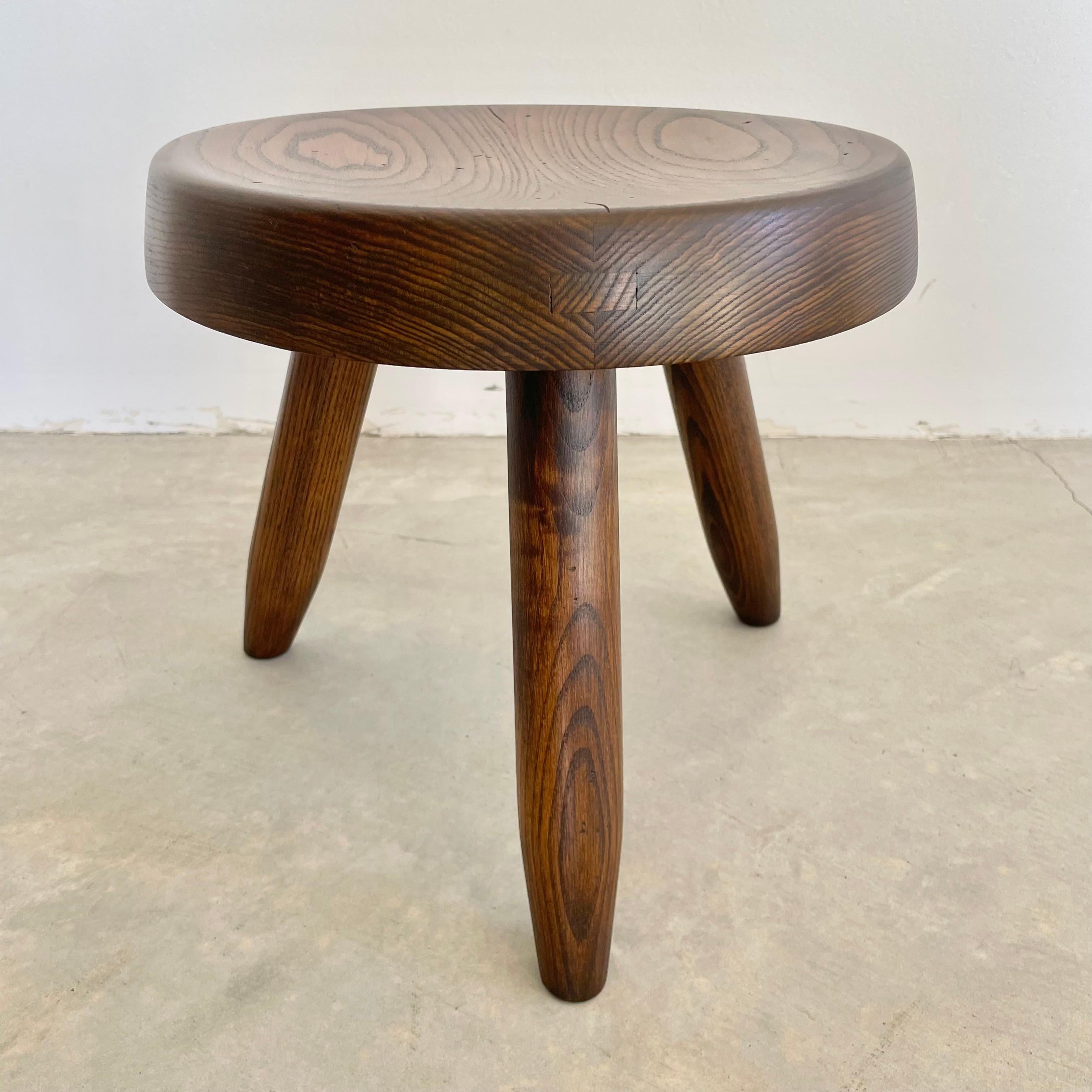 Collectible Berger stool by Charlotte Perriand in an elegant dark finish. Circa 1950s. You can find this stool featured in the Charlotte Perriand complete works Volume 2.