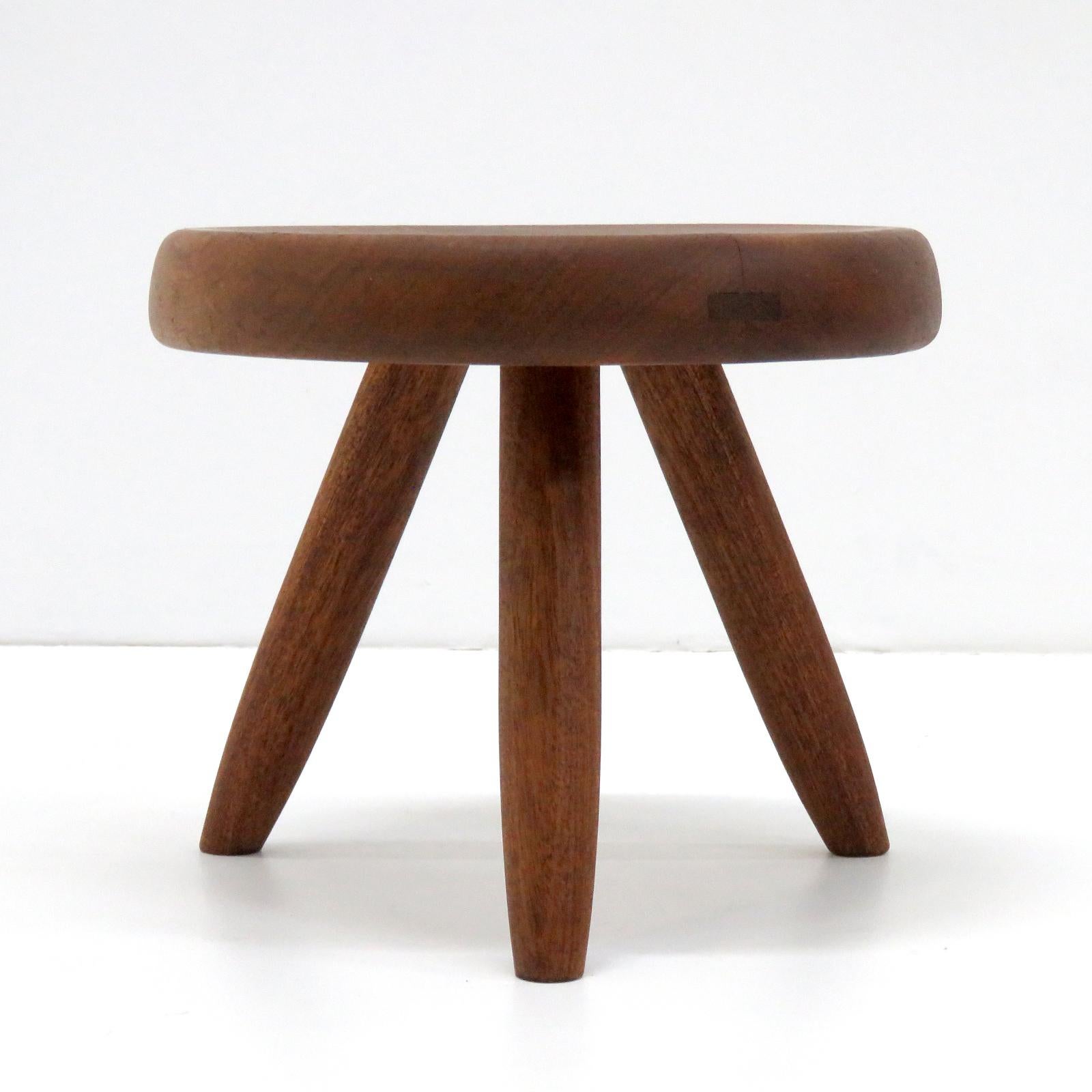 Wonderful wooden stool on the typical tripod base, designed by Charlotte Perriand, distributed by Steph Simon made of oak with the typical Perriand connection on its tripod base.