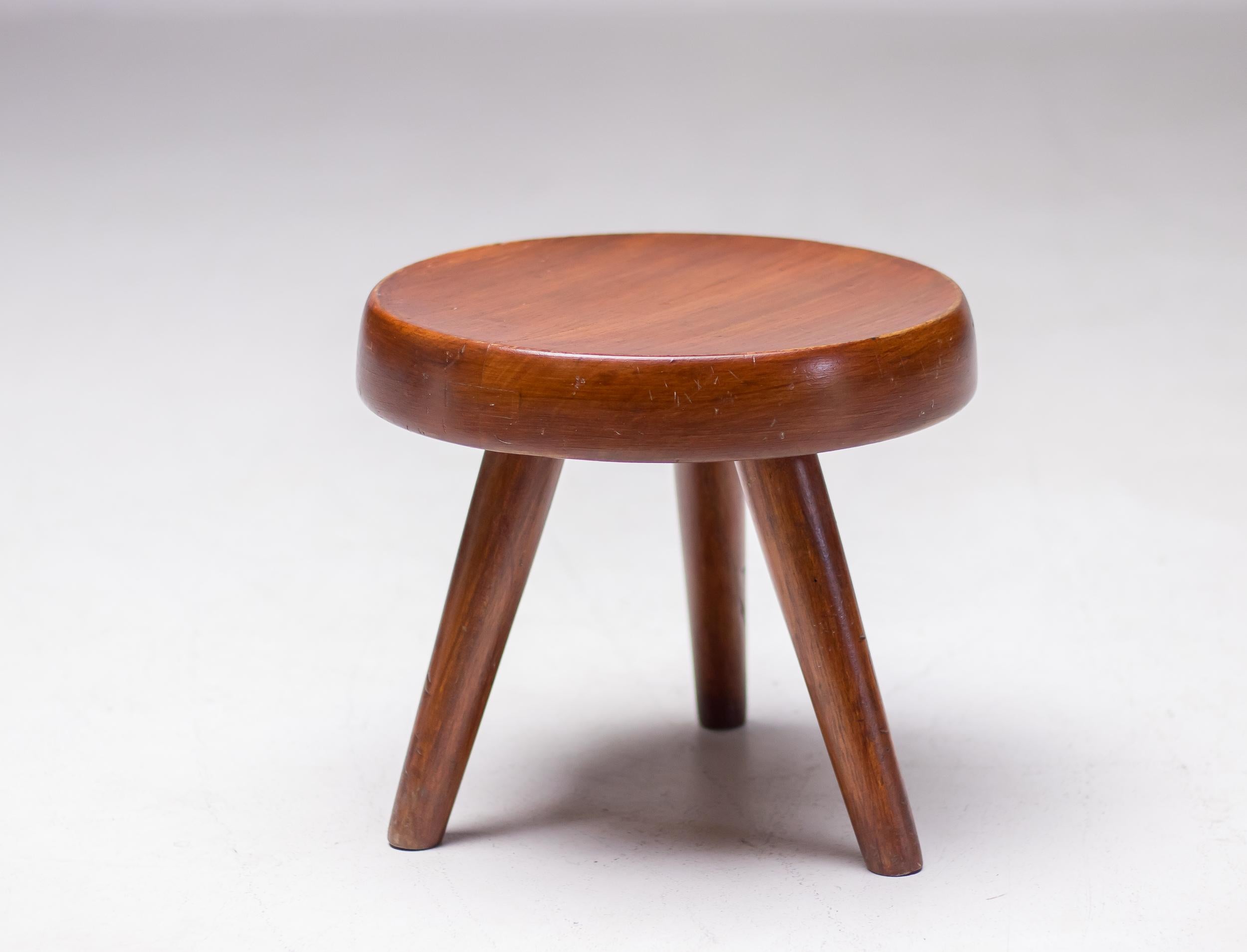 Original low stool or tabouret, known as the Berger Stool, designed by Charlotte Perriand. 
Inspired by pastoral mountain life, the design makes use of typical materials found in the Alps. Exquisitely handcrafted in mahogany using traditional