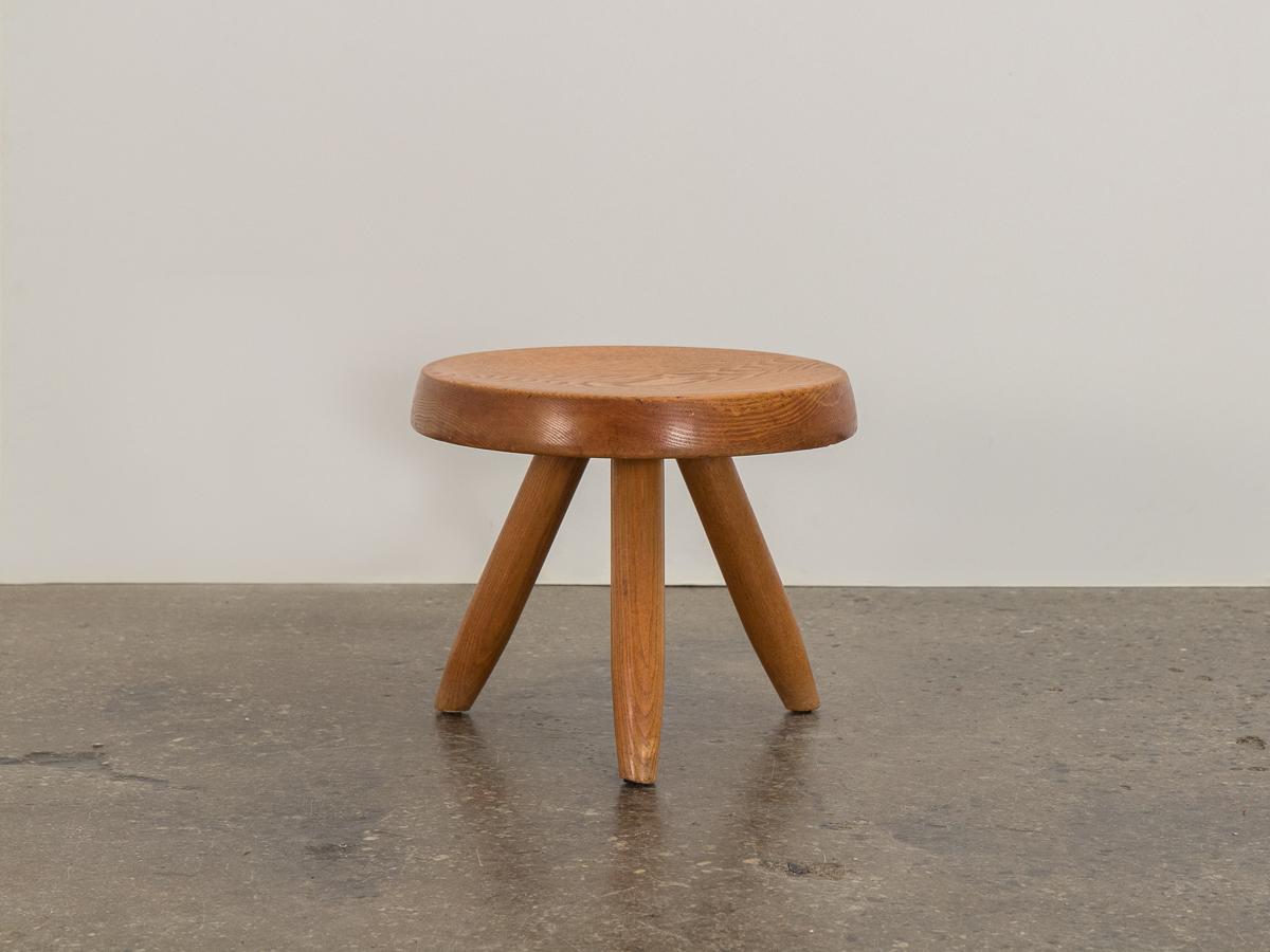 Original Charlotte Perriand, Berger stool for Steph Simon Galleries. This tabouret is made of solid oak wood with striking grain throughout its surface. Supported by a tripod of tapered, turned legs. Honest aging and patina are present in our