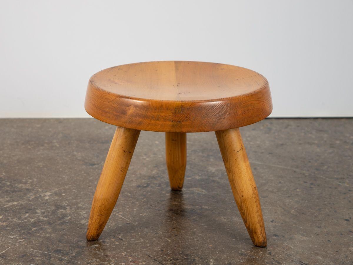 Original low stool or tabouret, well known as the Berger Stool, designed by Charlotte Perriand. Inspired by pastoral mountain life, the design makes use of typical materials found in the Alps. Exquisitely handcrafted using traditional woodworking