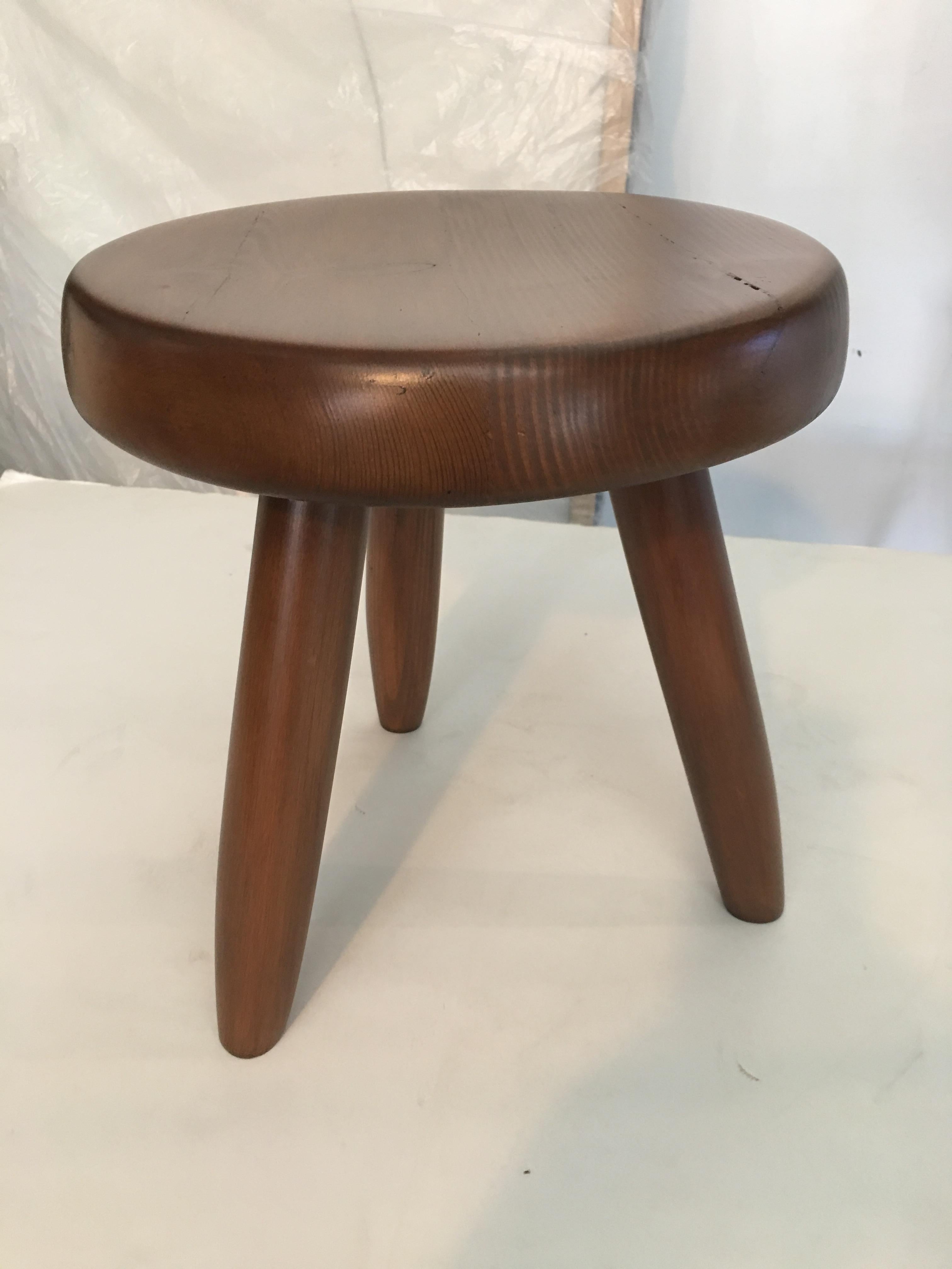 Beautiful and iconic Berger stool by Charlotte Perriand. Stained solid wood, c.1950s.