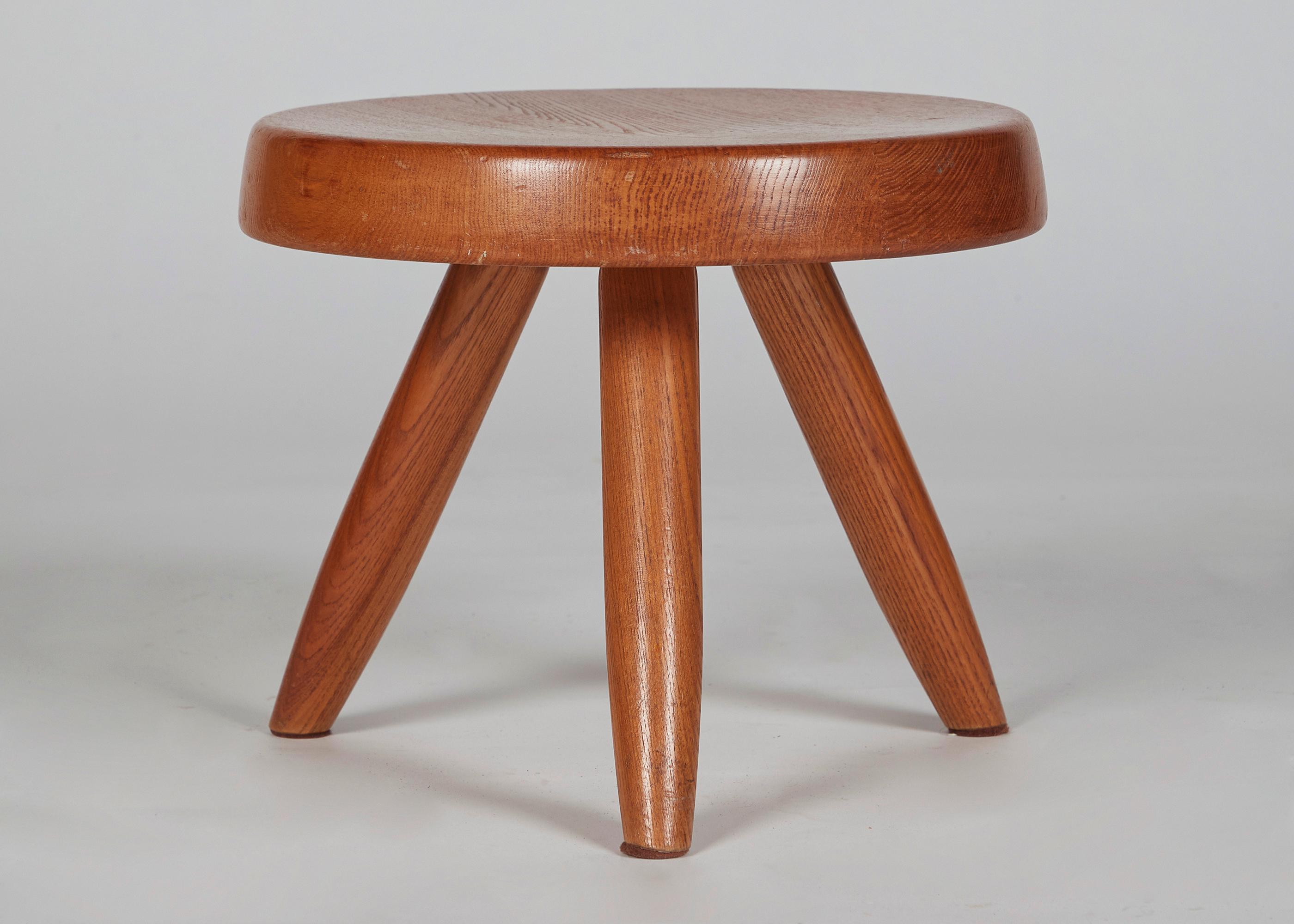 A perfectly proportioned three legged stool in the great French designer's signature aesthetic.