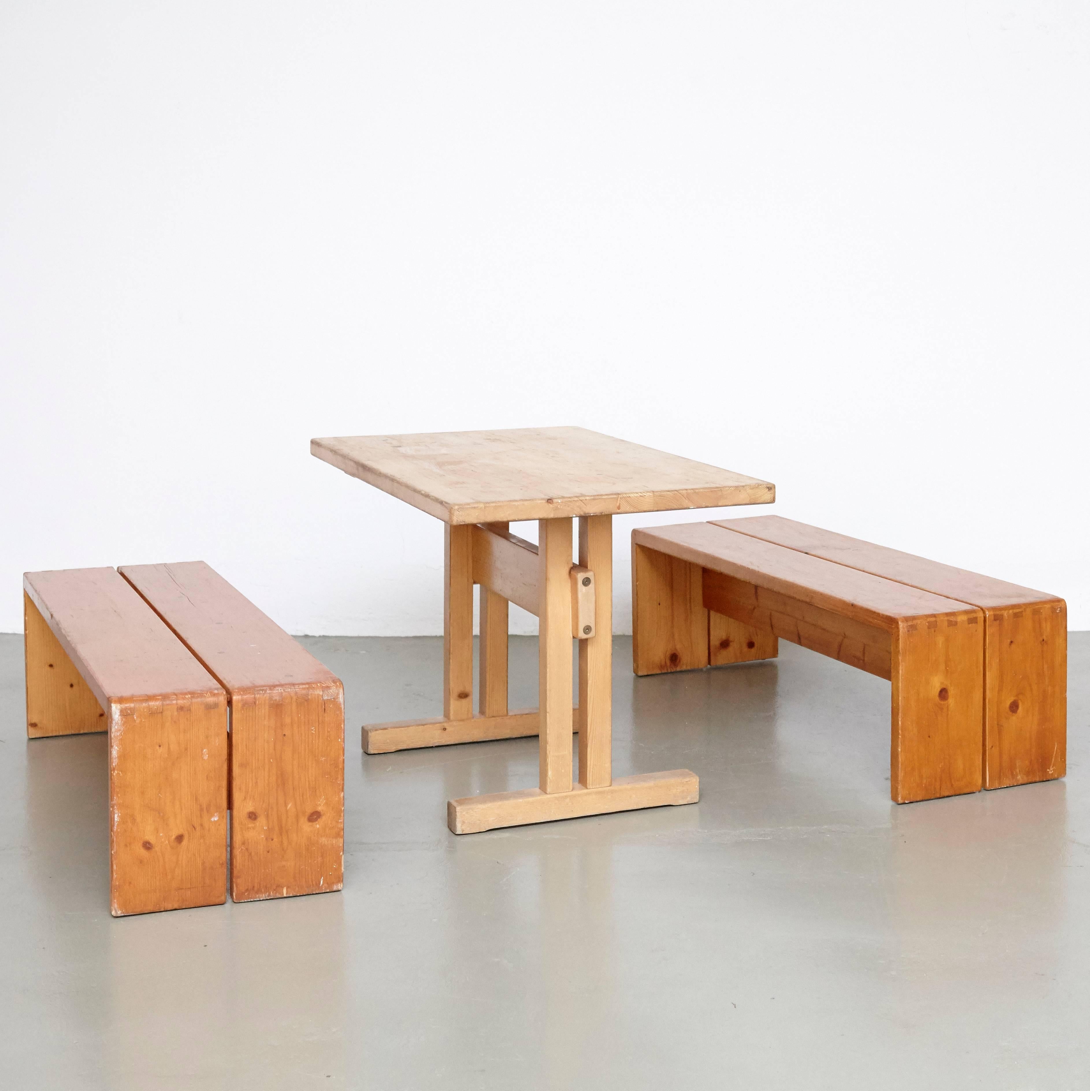 Set of table and benches designed by Charlotte Perriand for Les Arcs ski Resort, circa 1960, manufactured in France.

Pinewood.

In good original condition, with minor wear consistent with age and use, preserving a beautiful patina.

Charlotte