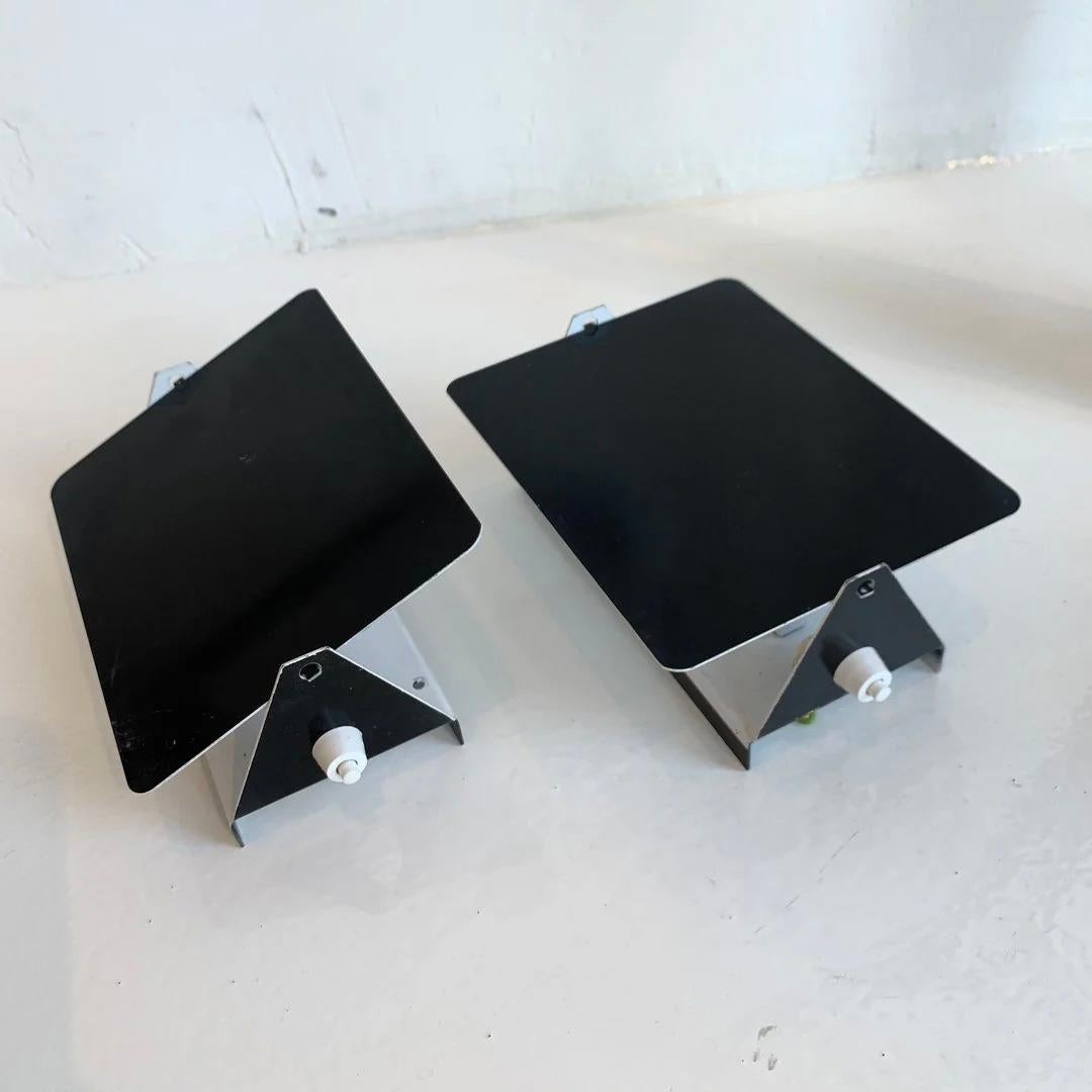 Black Charlotte Perriand CP1 sconces. Made in the 1960s. Painted steel. Newly rewired for US standards. 12 in stock and available in black. Priced individually.

Other colors and quantities available in separate listings.

Available at our Los