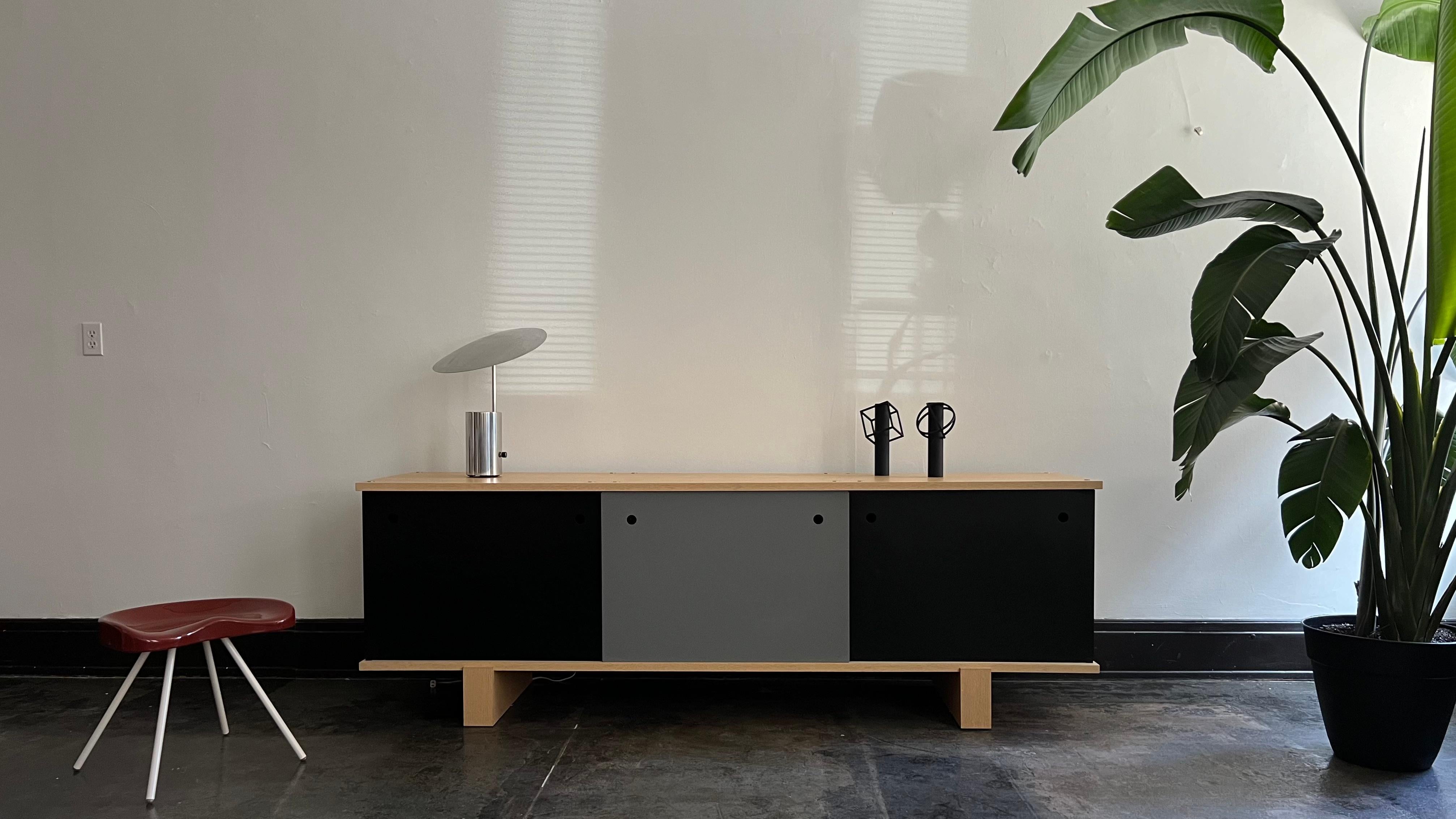 The Nuage Bloc Bahut implements Charlotte Perriand's system of modularity into a credenza. Simple at its core, the Nuage Bloc Bahut consists of individual vertical metal components and oak horizontal components, connected by threaded rods at the