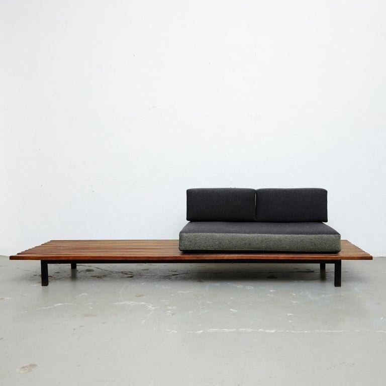 Bench from Cite Cansado, Mauritania, designed by Charlotte Perriand
wood, lacquered metal and fabric.

In good original condition, with minor wear consistent with age and use, preserving a beautiful patina. 

The cushions has been produced now
