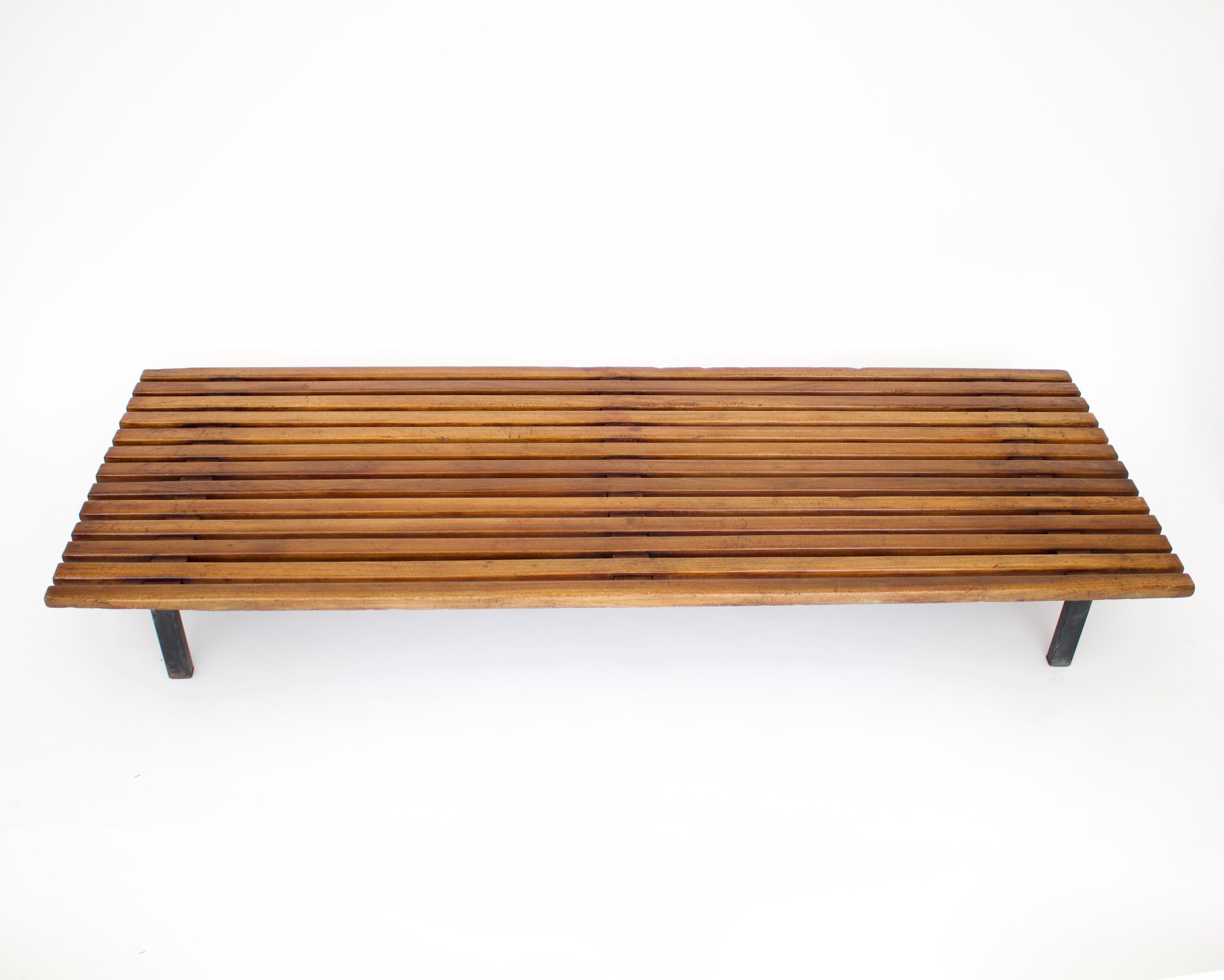 Bench designed by Charlotte Perriand, circa 1950. Manufactured by Steph Simon (France), circa 1950. 
Mahogany wood, lacquered metal frame and legs. 
Provenance: Cansado, Mauritania (Africa).
In original condition, with minor wear consistent with age