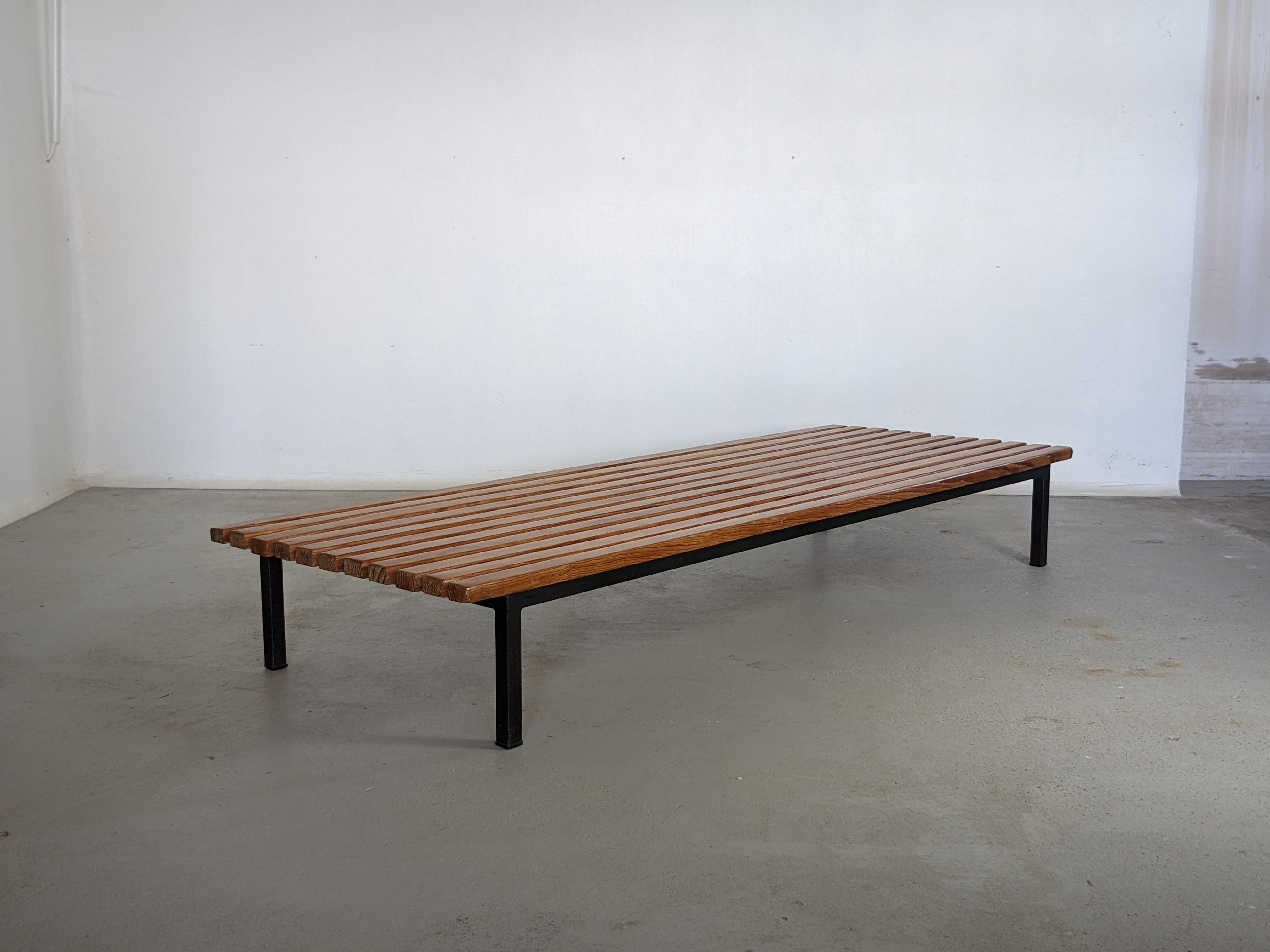 Slat bench or coffee table designed by Charlotte Perriand and produced by Steph Simon. 
It was made and used in the North African mining town of Cansado, Mauritania in the late 1950s. 
Solid ash wood slats on a metal frame with four legs.