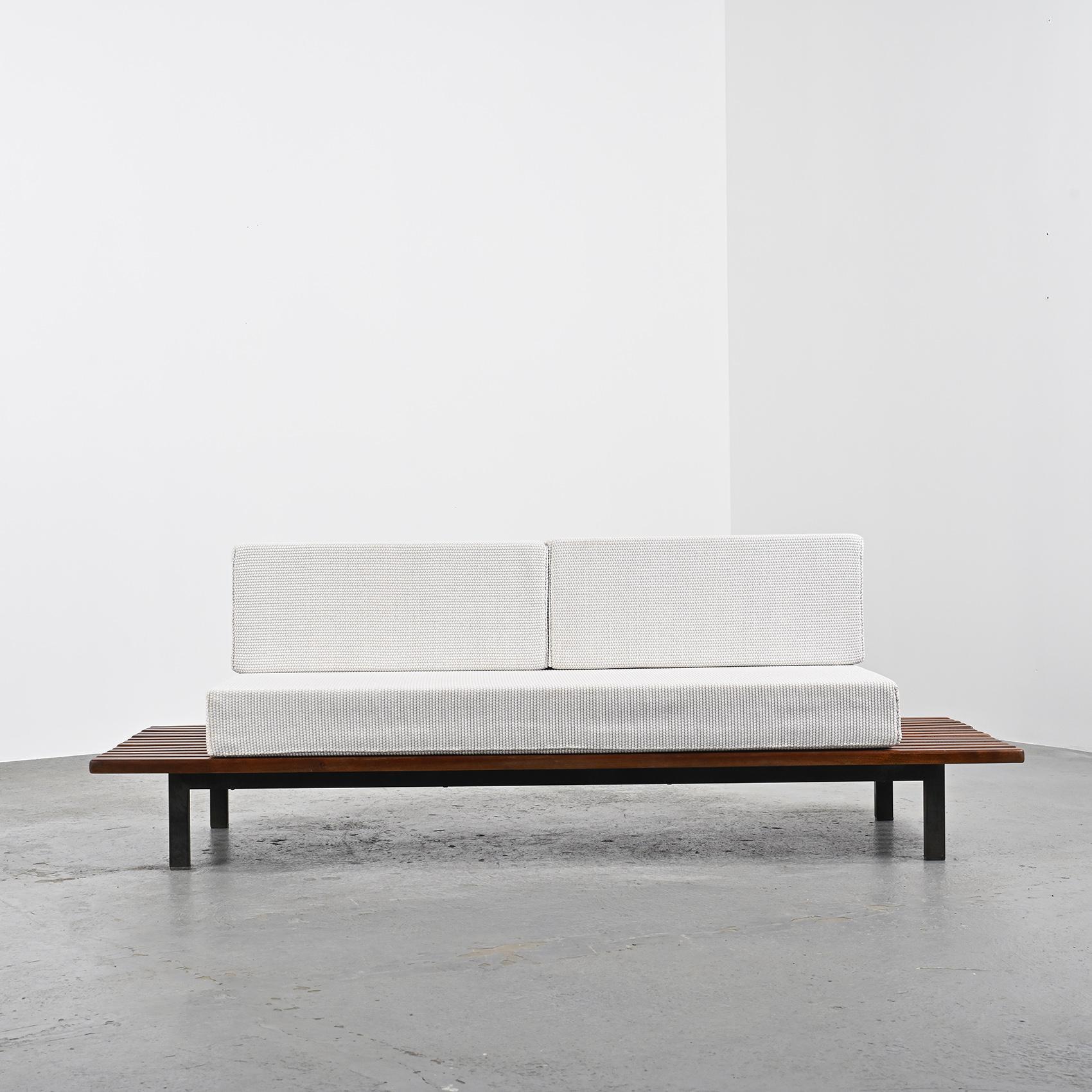 By Charlotte Perriand, a thirteen mahogany slats bench resting on black lacquered metal legs. It can also be stunning as a low table in a living room.

The mattress and cushions have be renovated in pebble stone Nobilis woolen cloth.

Cansado is a