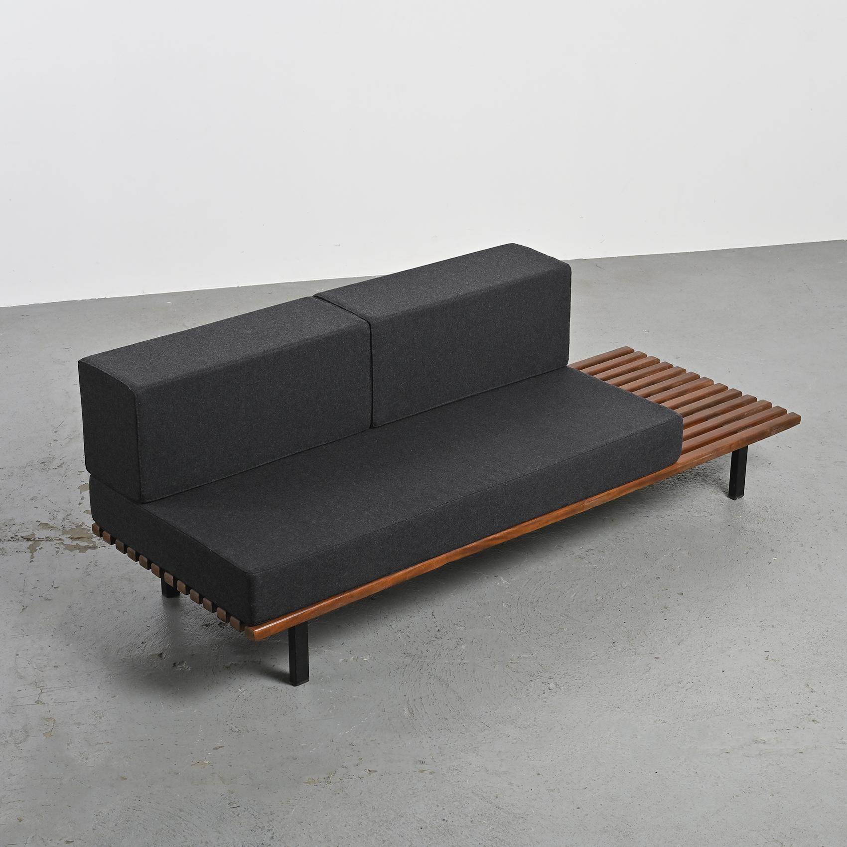 By Charlotte Perriand, a thirteen mahogany slats bench resting on black lacquered metal legs. It can also be stunning as a low table in a living room.

The mattress and cushions have be renovated in dark grey Nobilis woolen cloth.

Cansado is a
