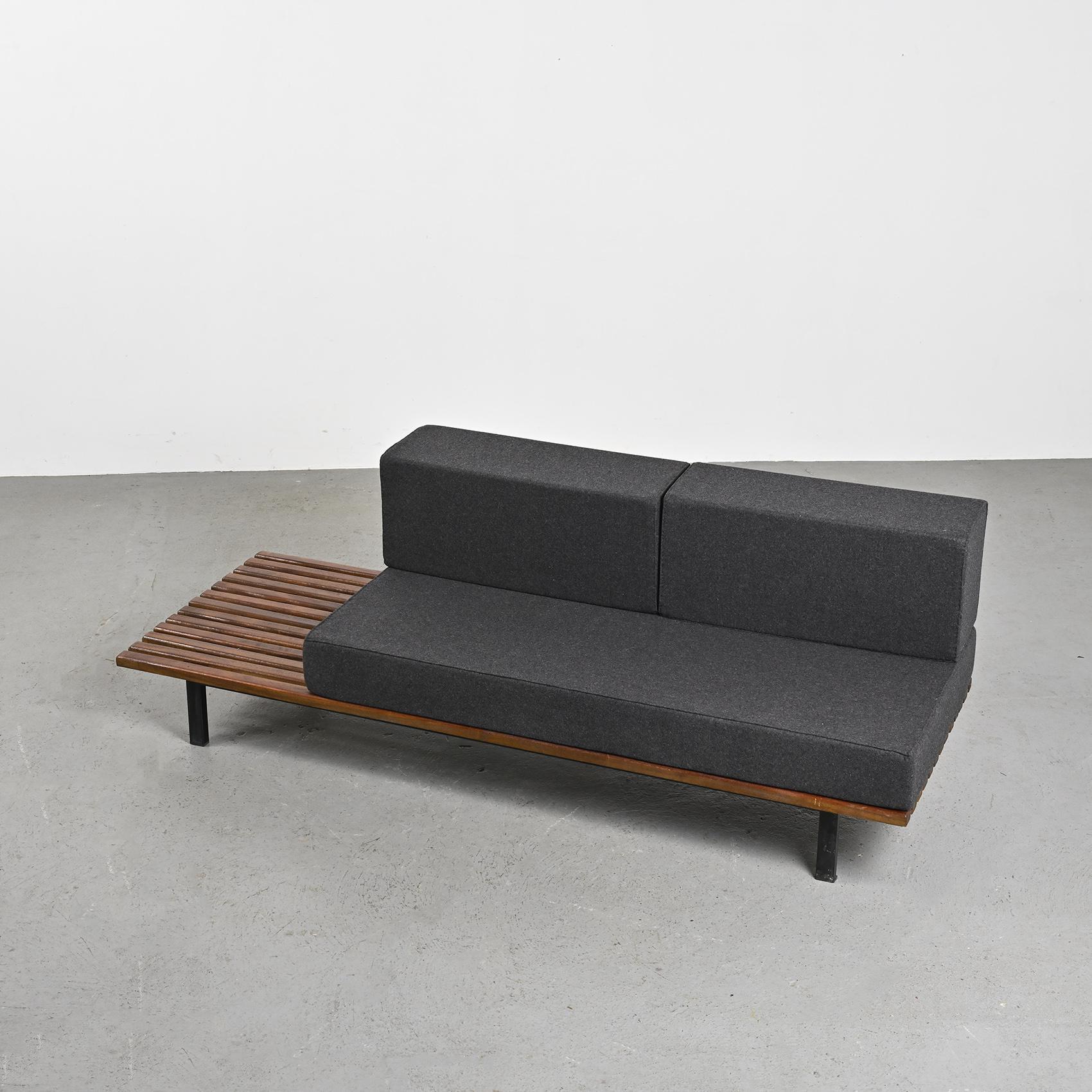 By Charlotte Perriand, a thirteen mahogany slats bench resting on black lacquered metal legs. It can also be stunning as a low table in a living room.

The mattress and cushions have be renovated in dark grey Nobilis woolen cloth.

Cansado is a