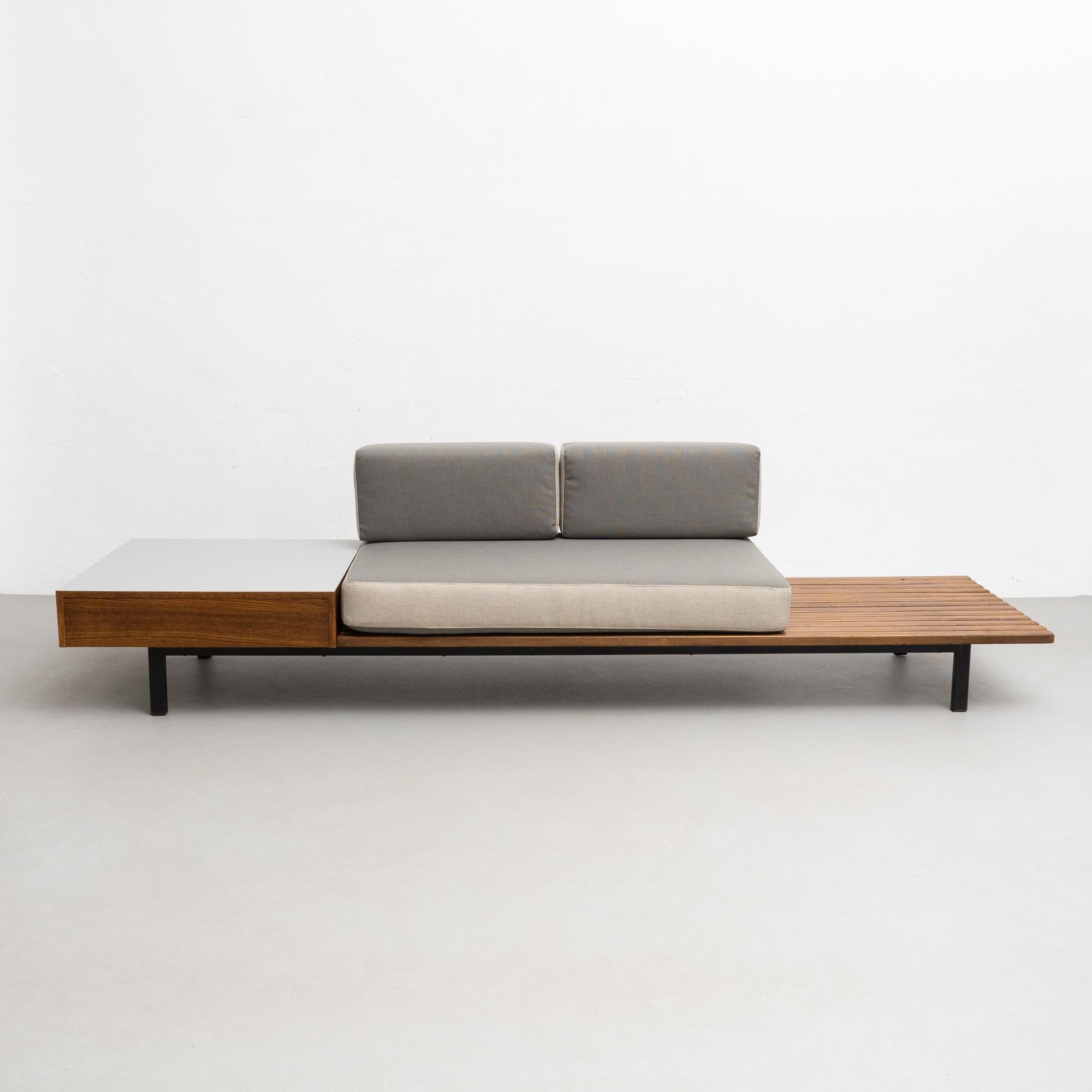 Bench with side table and drawer and cushions from Cite Cansado, Mauritania.

Designed by Charlotte Perriand in France circa 1958.

Mahogany wood, oak, plastic laminated covered wood, lacquered metal and fabric.

In good original condition,