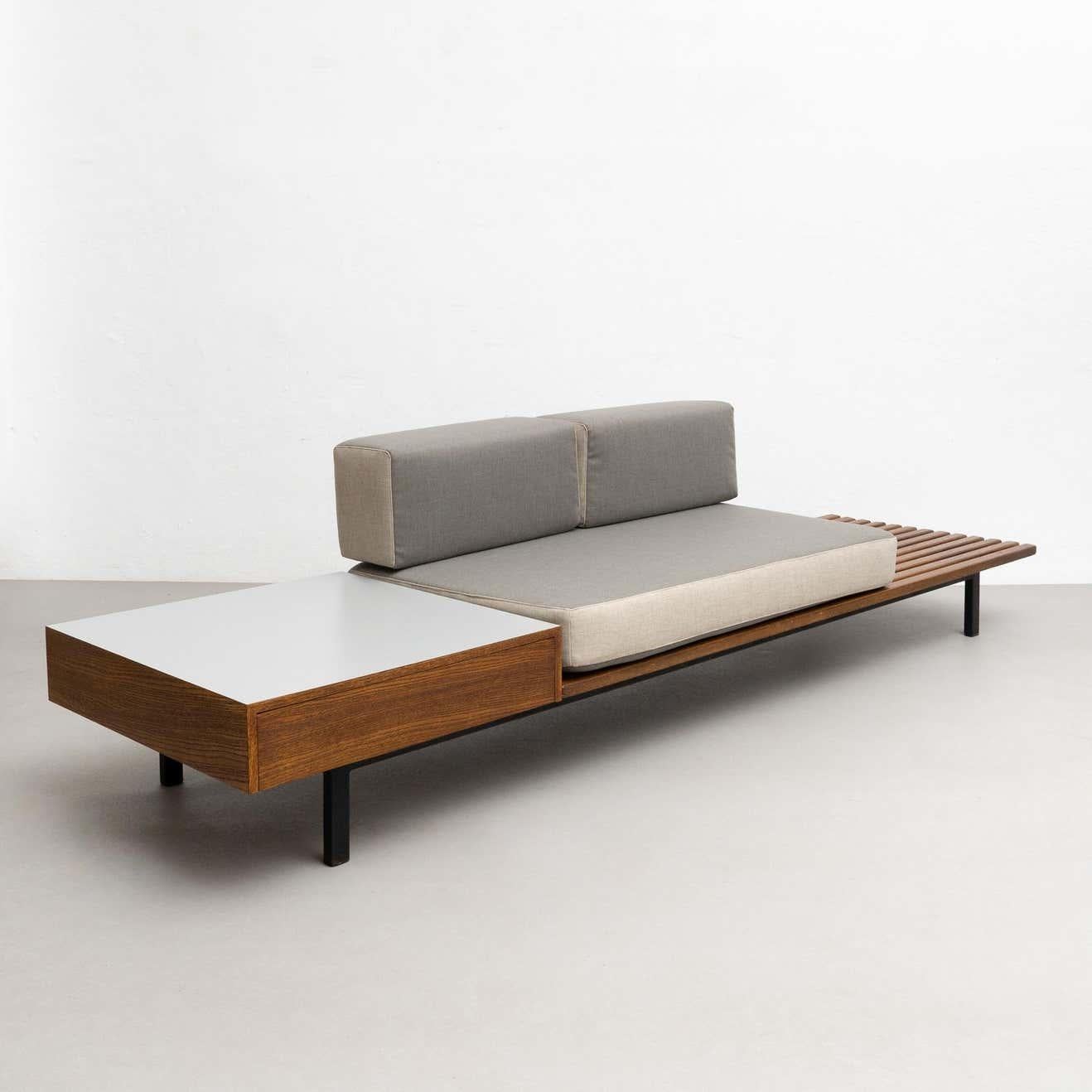 Bench with side table and drawer and cushions from Cite Cansado, Mauritania.

Designed by Charlotte Perriand in France circa 1958.

Mahogany wood, oak, plastic laminated covered wood, lacquered metal and fabric.

In good condition, with minor wear