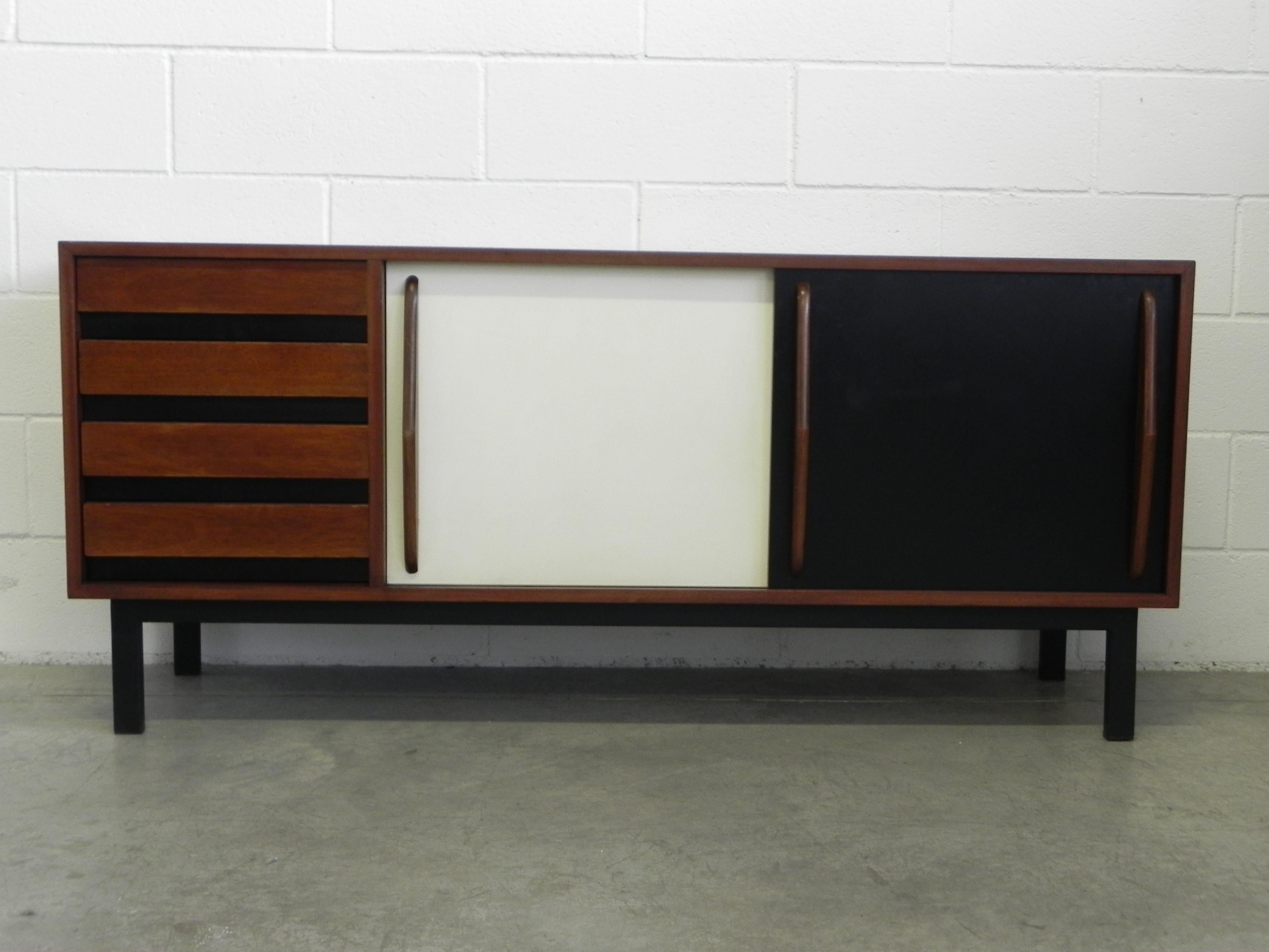 Sideboard designed by Charlotte Perriand, circa 1960. Manufactured by Steph Simon (France). Steel base, wood structure and grips, lacquered sliding doors. In good original condition, with minor wear consistent with age and use, complete restored.