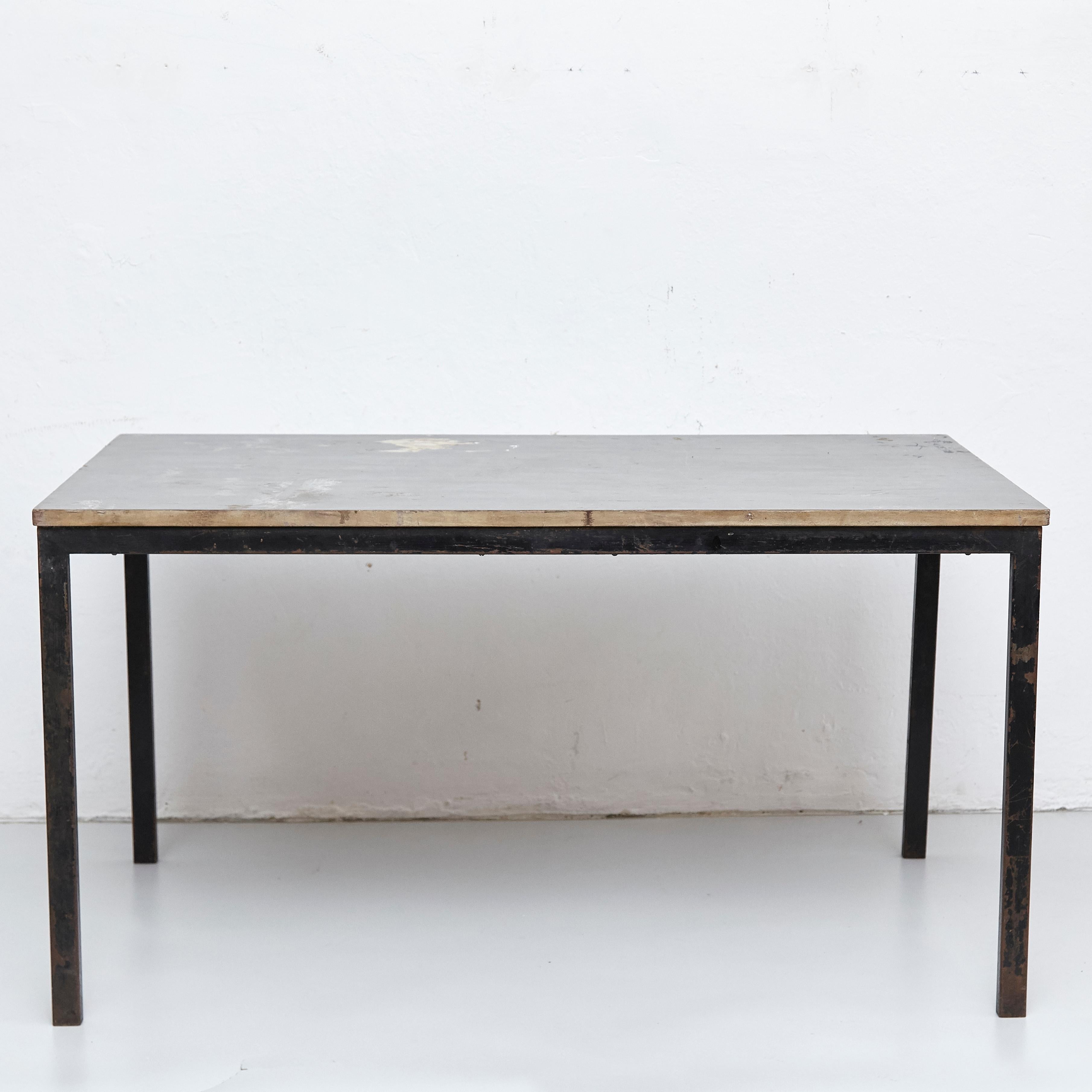 Table designed by Charlotte Perriand, circa 1950.

Wood, metal frame legs.

Provenance: Cansado, Mauritania (Africa).

In original condition, with wear consistent with age and use, preserving a beautiful patina. 

Charlotte Perriand