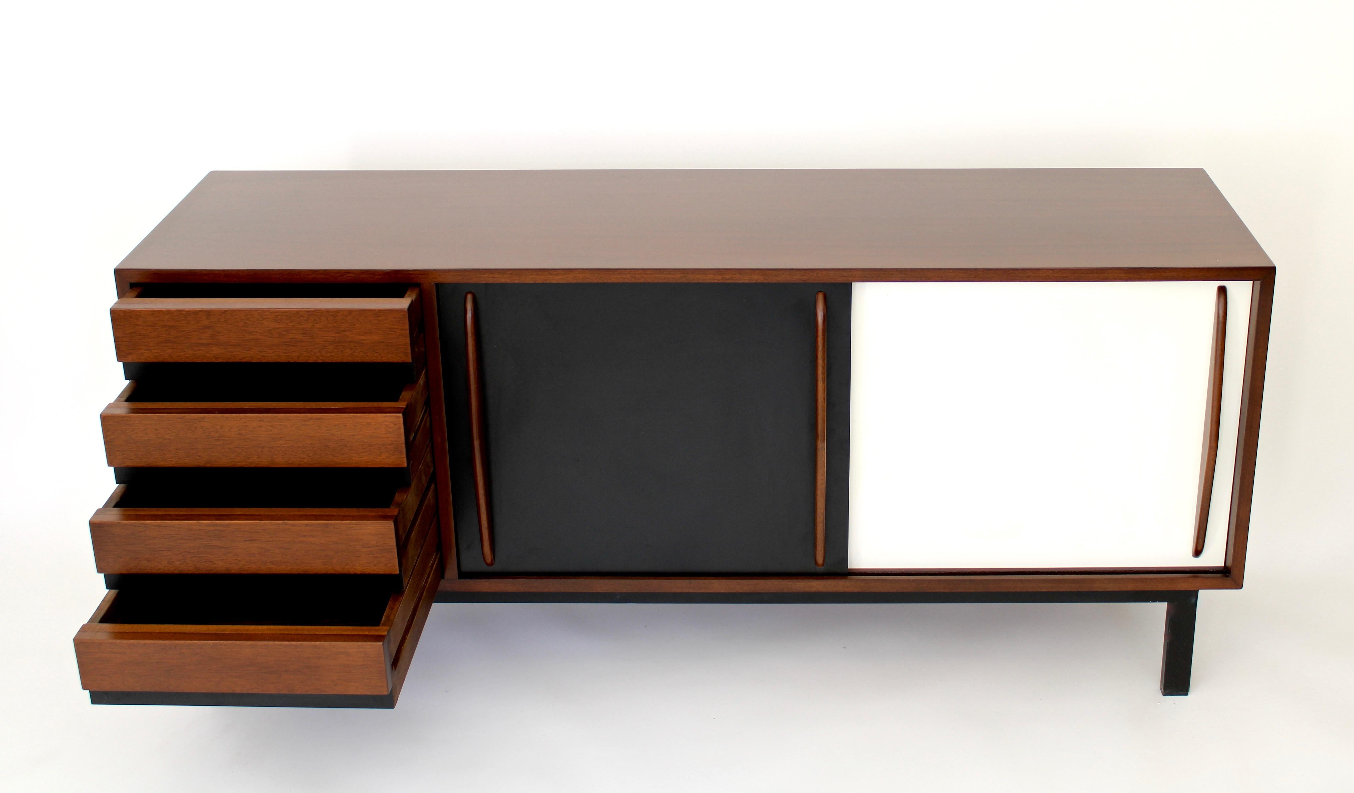 This Cansado four-drawer and sliding door sideboard or buffet was designed by Charlotte Perriand circa 1950 for the city of the same name in Mauritania.
It was manufactured in France and editions by Steph Simon, her longtime dealer.
It has a steel