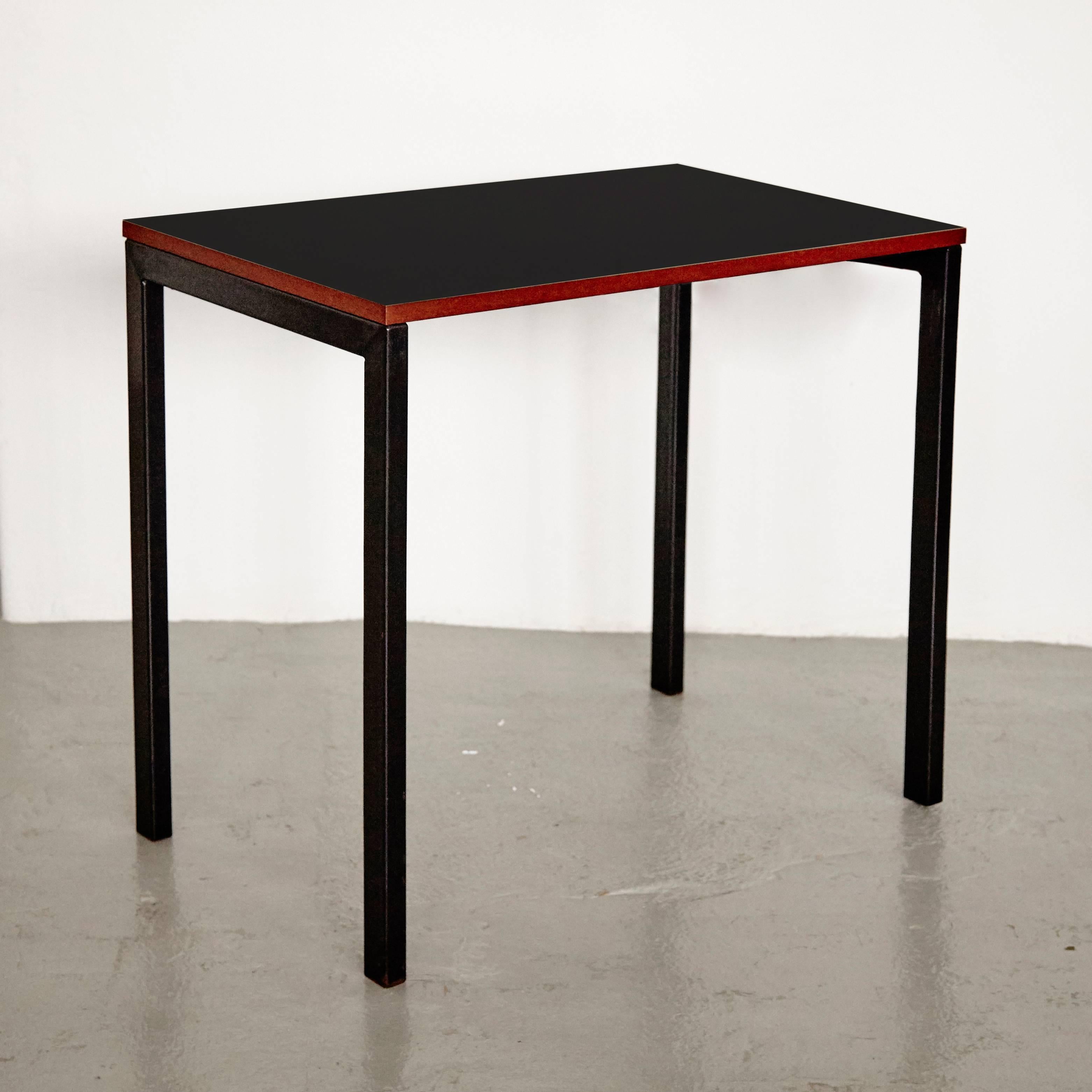 Console designed by Charlotte Perriand, circa 1958.
Manufactured in France, circa 1958.

Black laminated plastic-covered plywood, painted steel.

In good original condition, with minor wear consistent with age and use, preserving a beautiful