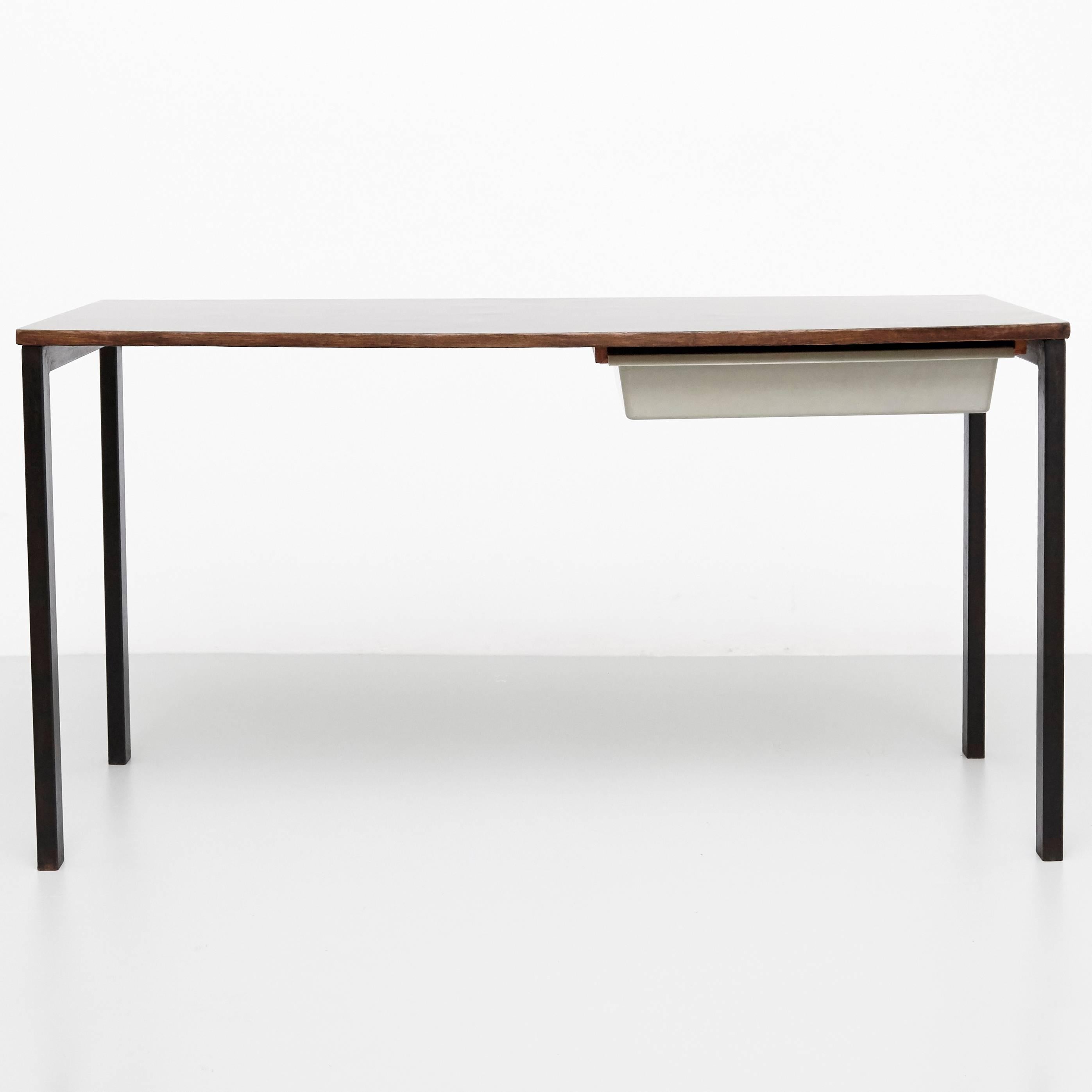Console designed by Charlotte Perriand, circa 1958.
Manufactured in France, circa 1958.
Black laminated plastic-covered plywood, painted steel and grey moulded plastic.

 Drawer moulded with Modele Charlotte Perriand or Brevete S.G.D.G.

In