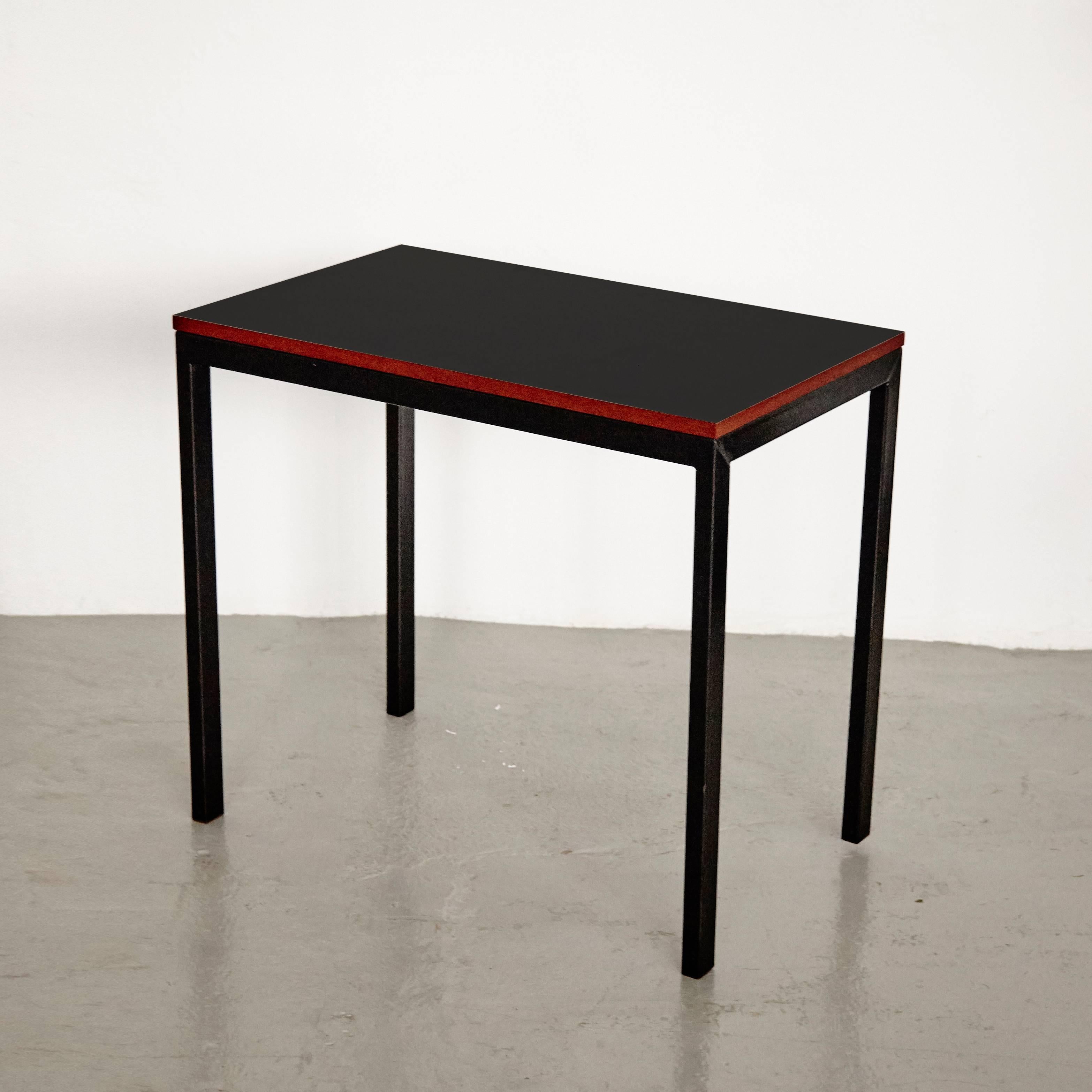 Console designed by Charlotte Perriand, circa 1958.
Manufactured in France, circa 1958.

Black laminated plastic-covered plywood, painted steel and red moulded plastic.

Drawer moulded with Modele Charlotte Perriand or Brevete S.G.D.G.
Some