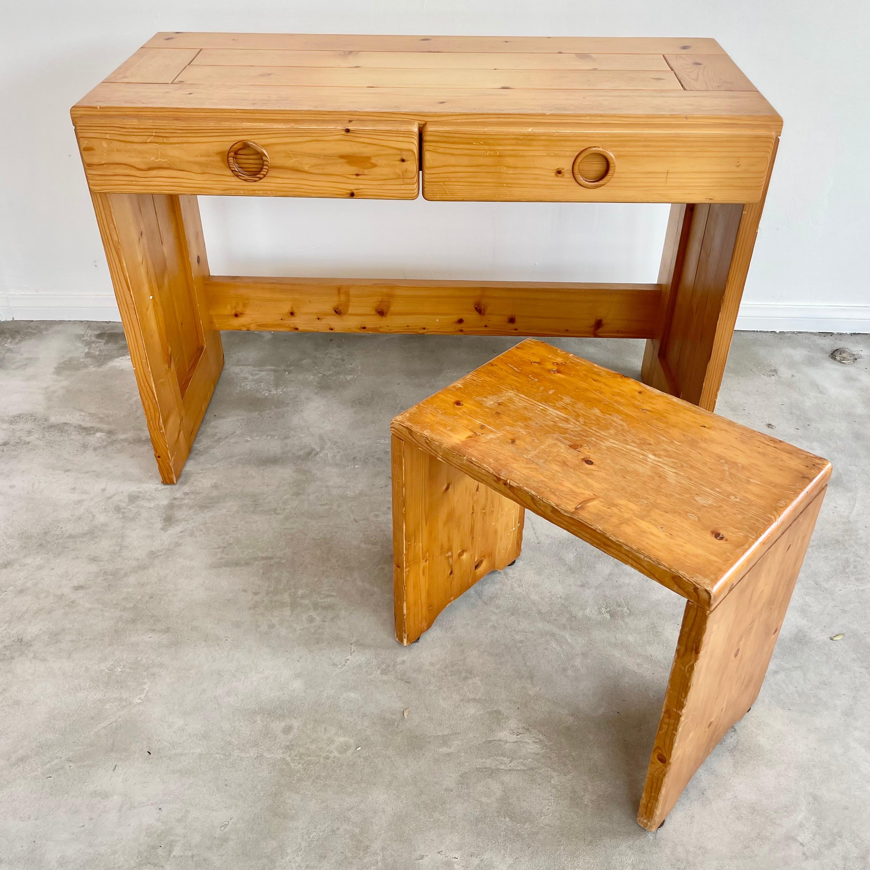 Rare Charlotte Perriand desk for Les Arcs. Circa 1960s. Comes with matching stool. This solid pine table can be used as a console or writing desk. Beautiful vintage condition and wear. Great vintage condition. Highly collectible piece of Charlotte