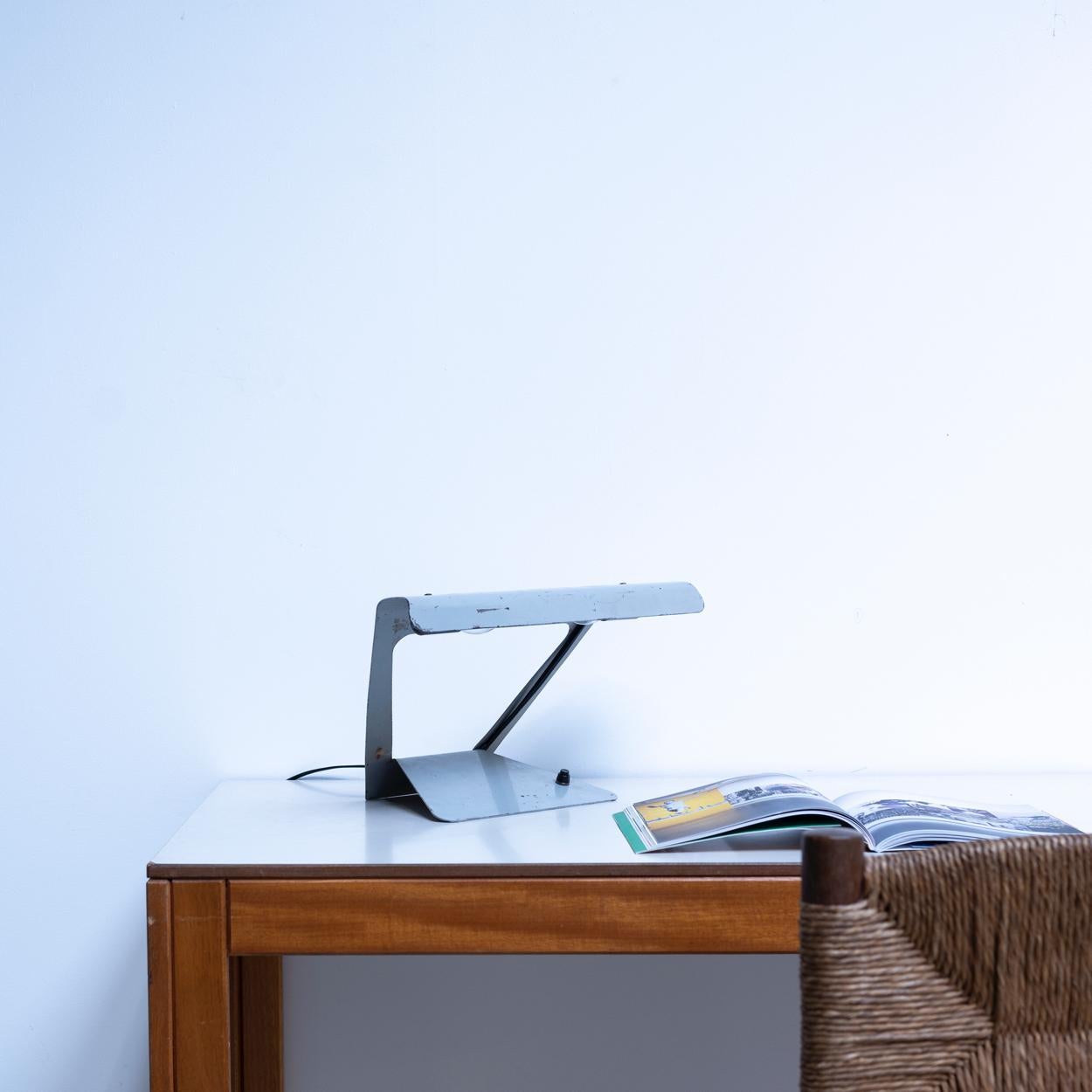 Desk lamp designed by Charlotte Perriand for Philips. Made by cutting and folding a single steel plate.
Fully rewired with two E17 sockets and can be used practically.