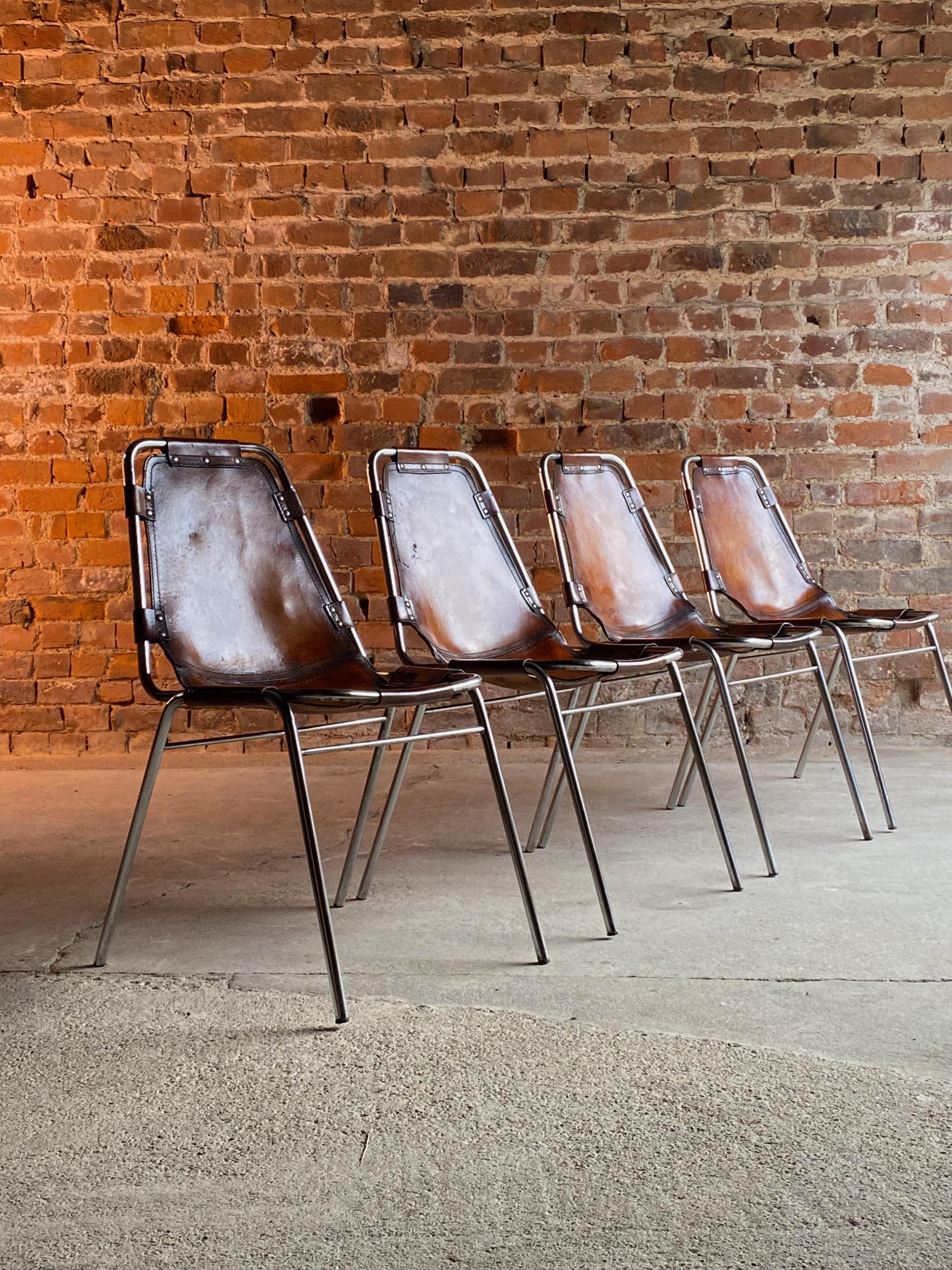 Charlotte Perriand dining chairs leather 4 Les Arcs 1970s set no: 2

Heavily patinated set of four tan leather 'Les Arcs' dining chairs designed by Charlotte Perriand for Cassina in the 1960s for the Les Arcs ski resort,  each chair consists of a