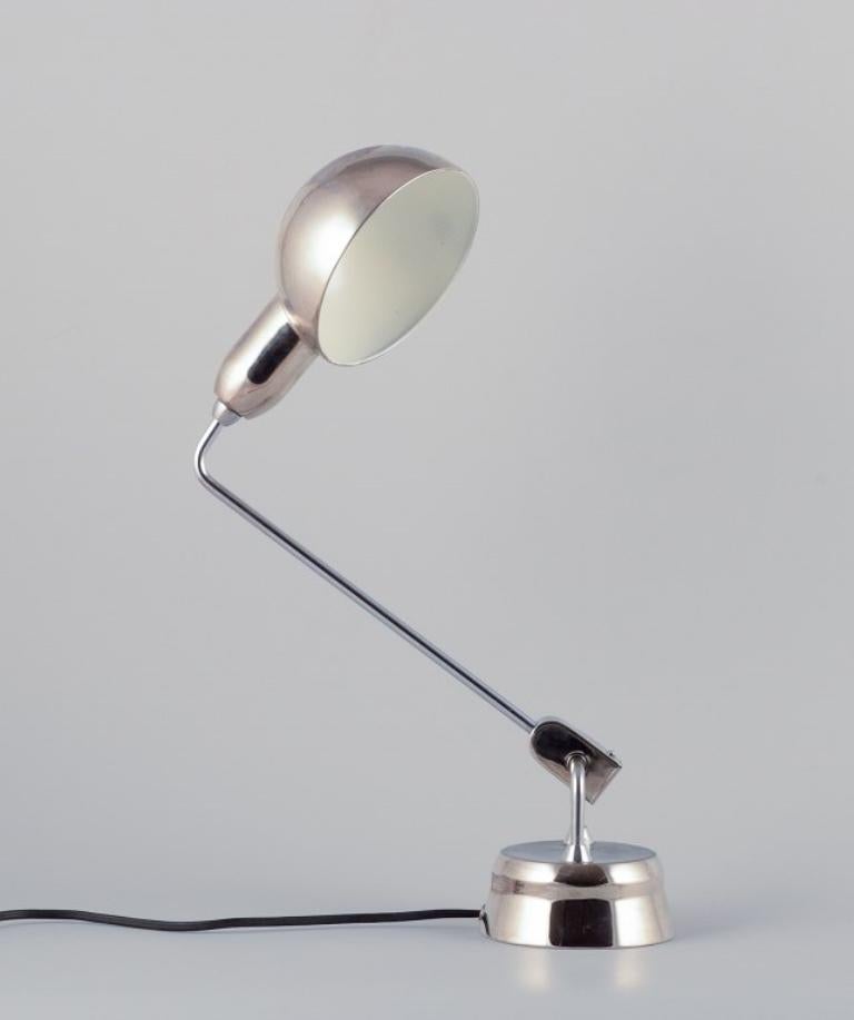Charlotte Perriand for Jumo, France. Desk lamp in chromed metal.
Model 600. 
1950/60s. 
In perfect condition. 
Dimensions: Height 44.0 cm, Foot diameter 10.0 cm
Lampshade diameter 13.3 cm.