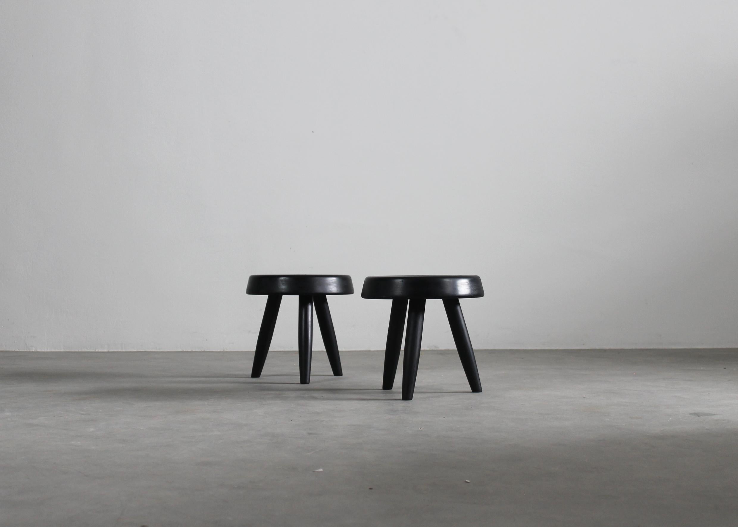 Charlotte Perriand: Set aus zwei schwarzen Hockern aus Holz, 1950er Jahre (Moderne der Mitte des Jahrhunderts)