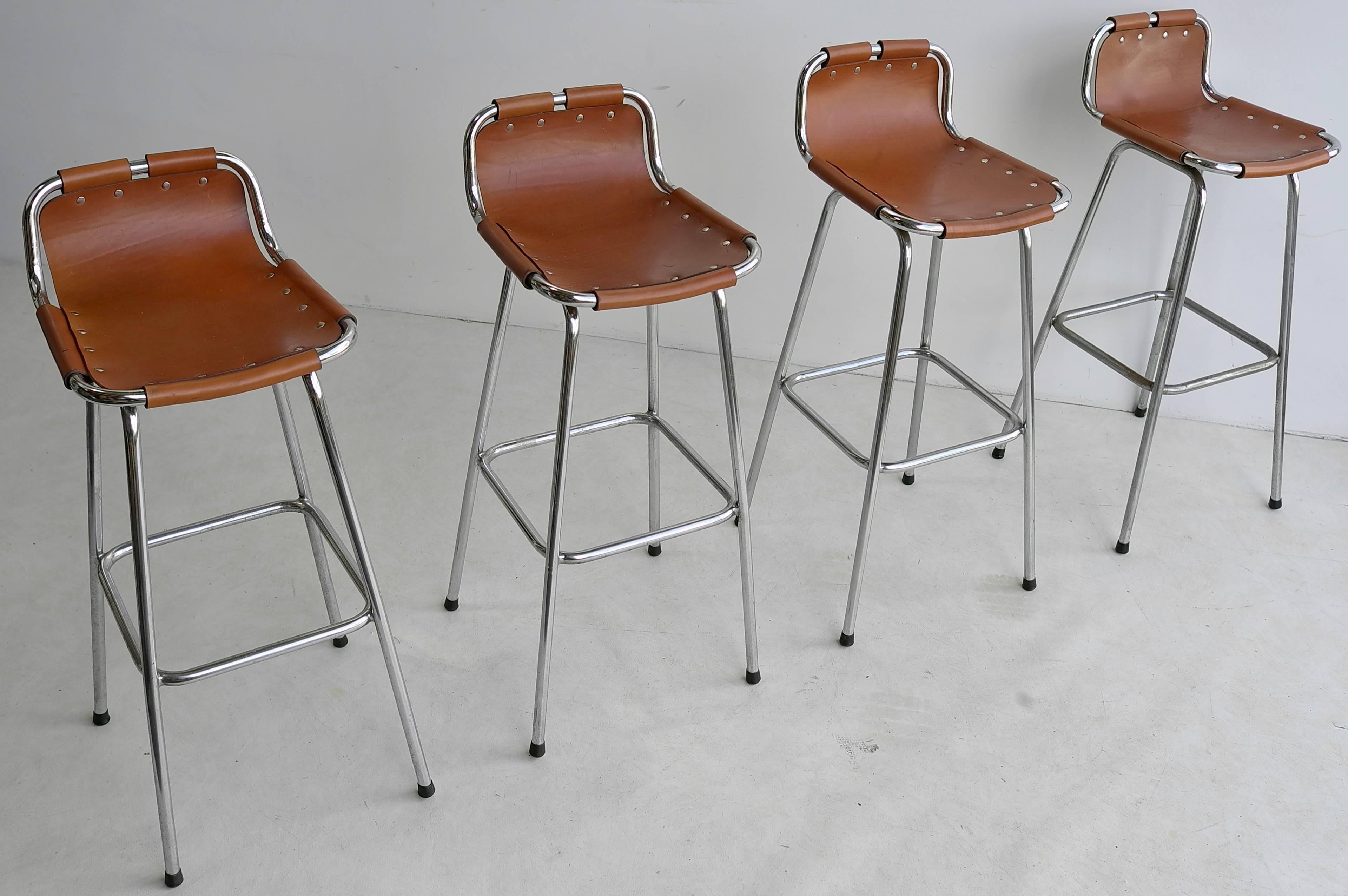 Set of leather barstools for Les Arc Ski Resort, France, 1960s.

Charlotte Perriand was a French architect and designer. Her work aimed to create functional living spaces in the belief that better design helps in creating a better society.  These