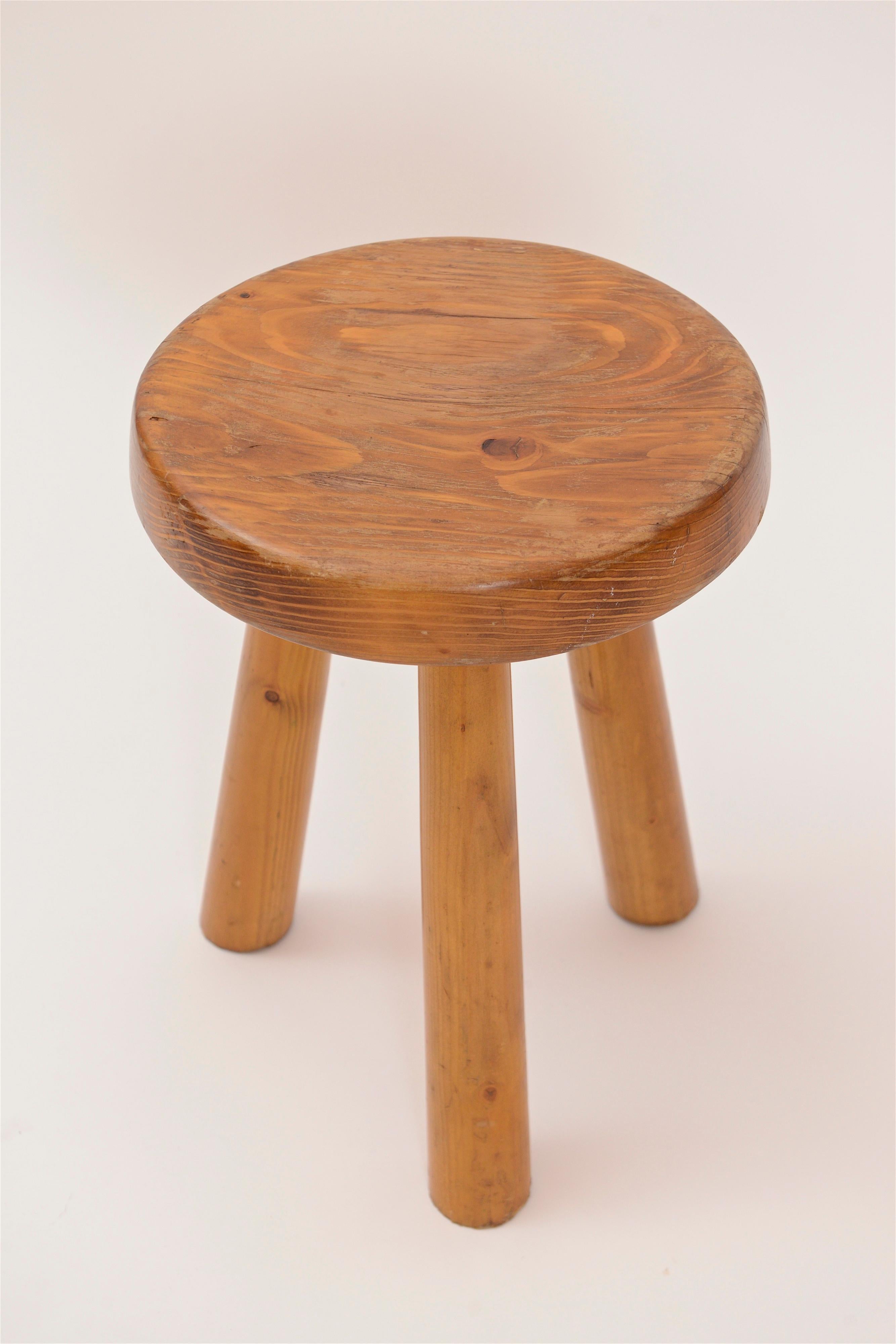 A beautifully simple three-legged pine stool designed by Charlotte Perriand, circa 1960. Produced for the famous French ski resort, ‘Les Arcs’, in the early sixties, these stools have become a design classic and an iconic piece within the Perriand