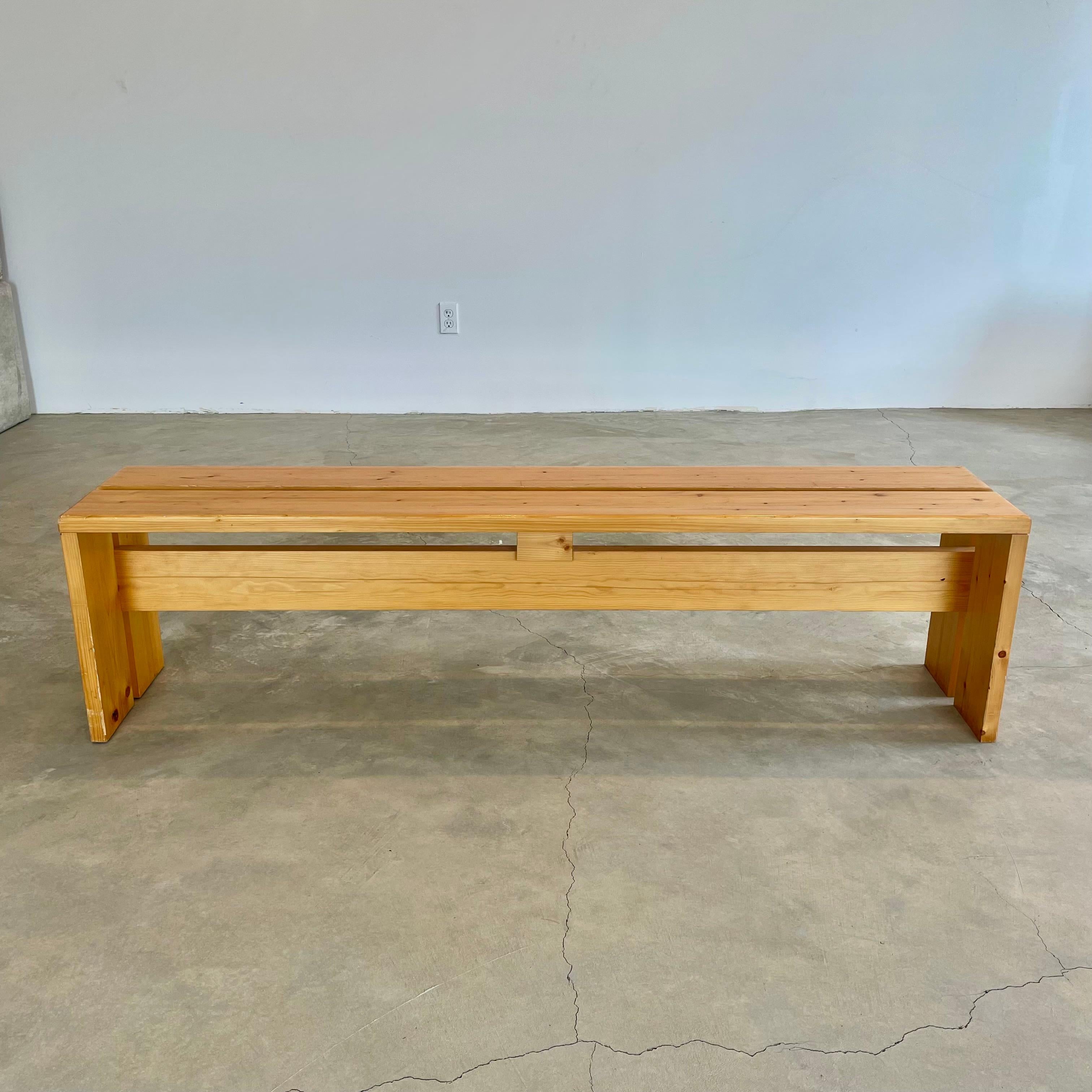 Classic pine 4 seater bench designed by Charlotte Perriand for the Les Arcs Ski Resort in France. A beautiful example of iconic Perriand design in an amazingly unusual length stretching 5.25 feet long. Pine was the wood of choice for much of the