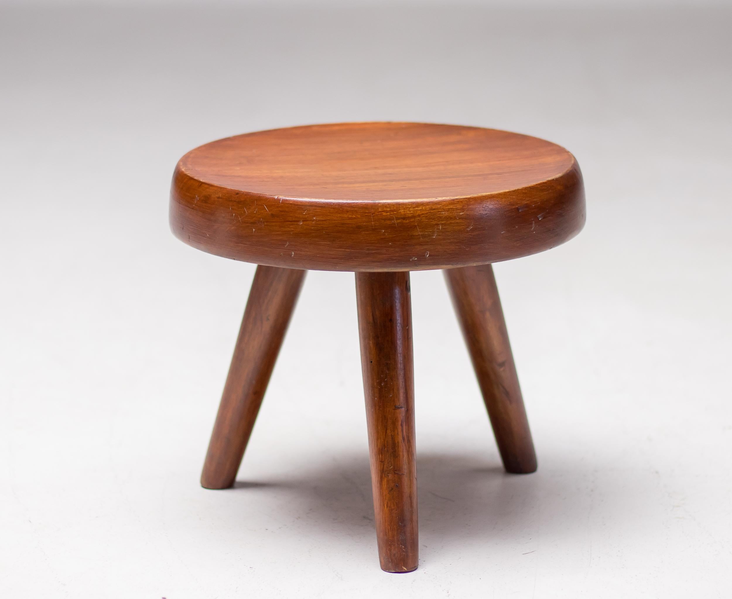 Original low stool or tabouret, known as the Berger Stool, designed by Charlotte Perriand. 
Inspired by pastoral mountain life, the design makes use of typical materials found in the Alps. Exquisitely handcrafted in mahogany using traditional