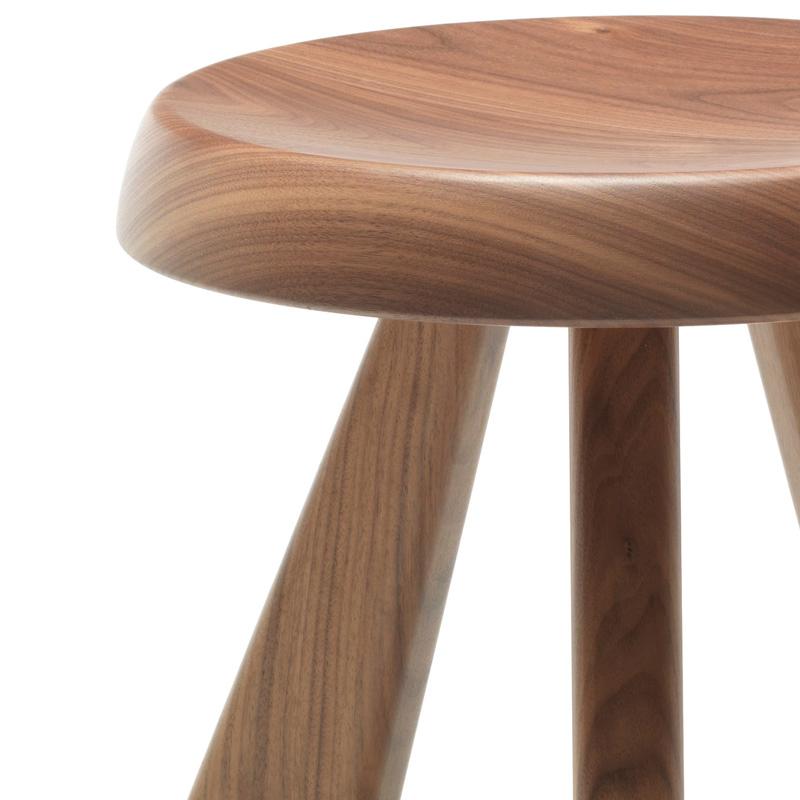 Stool model Meribel designed by Charlotte Perriand in 1953-61. 
American walnut.
Relaunched by Cassina in 2011.
Manufactured by Cassina in Italy.

Reclaiming simple materials and basic shapes, with an eye to architecture and mountain life, led
