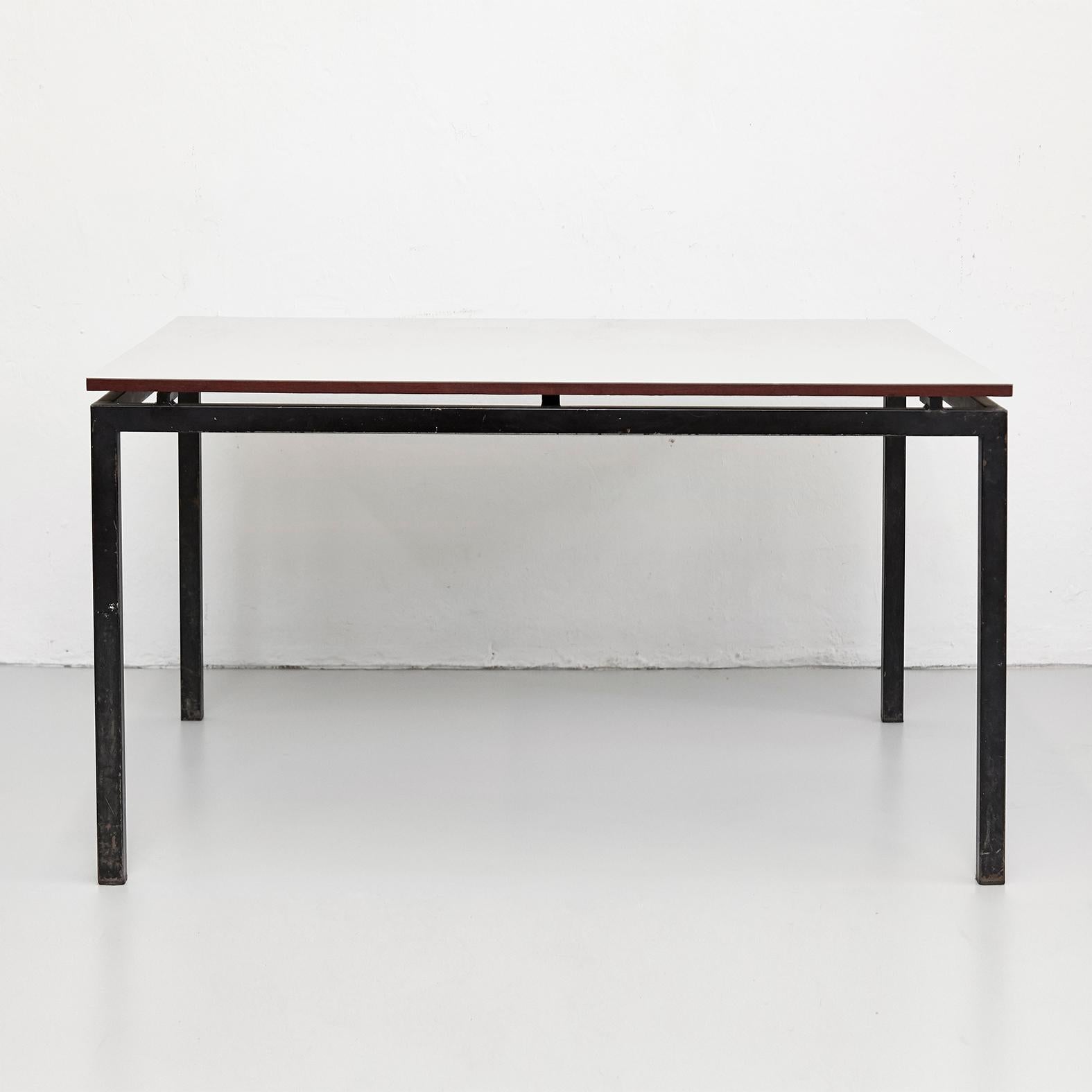 Table designed by Charlotte Perriand, circa 1950.

Wood with Formica, metal frame legs.

Provenance: Cansado, Mauritania (Africa).

In good original condition, with minor wear consistent with age and use, preserving a beautiful patina.