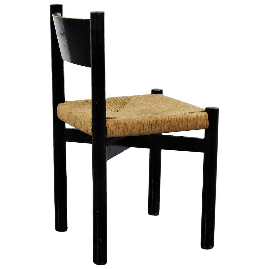 Dining chair, model Meribel, designed by Charlotte Perriand, circa 1950.
Manufactured by Georges Blanchon (France)
Black lacquered wood base and legs, and original rush seat.

In good original condition, with minor wear consistent with age and