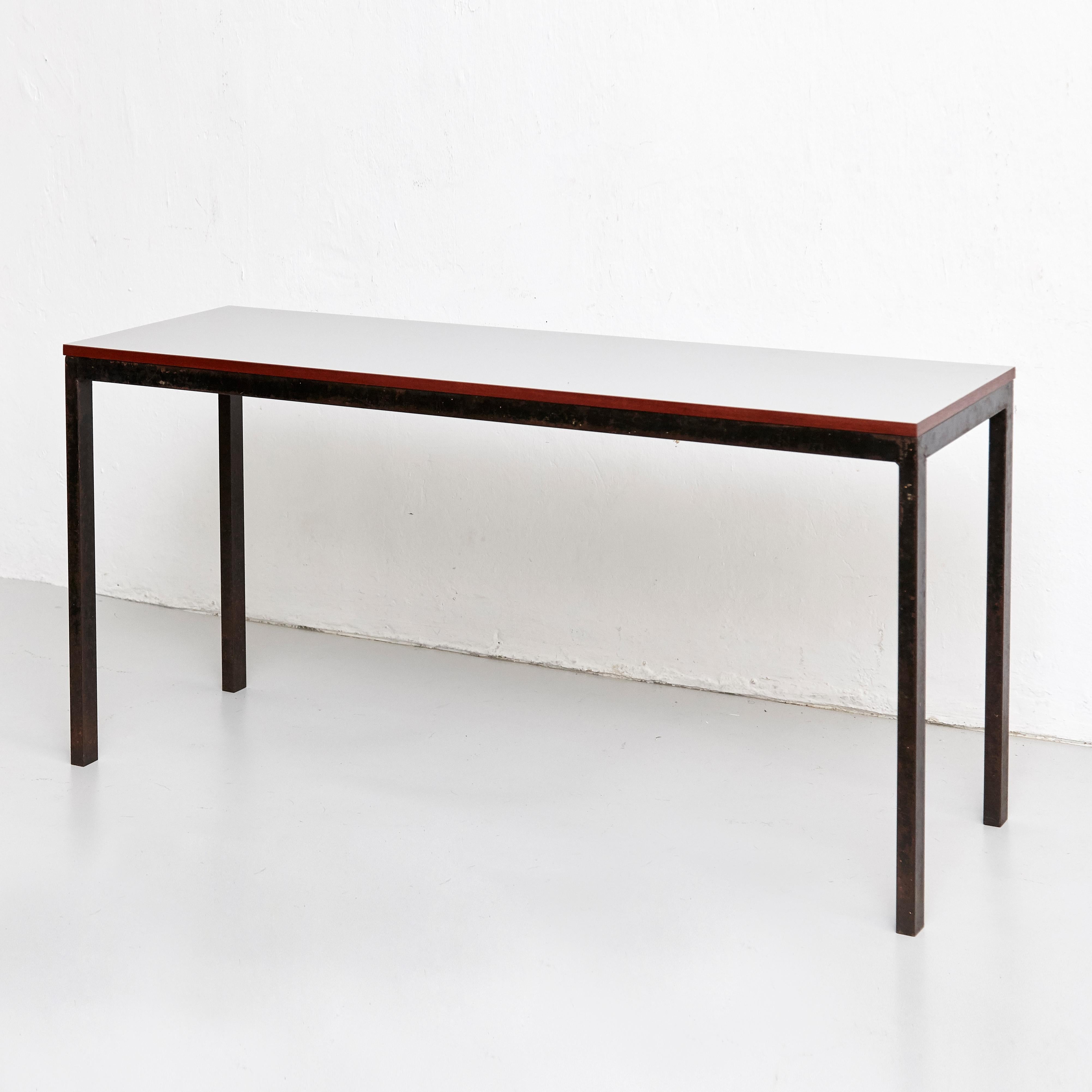 Console designed by Charlotte Perriand, circa 1950.
Manufactured in France, circa 1950.

Drawer moulded with Modele Charlotte Perriand or Brevete S.G.D.G.
Some break in the drawer as shown in the photo.

Grey laminated plastic-covered plywood,