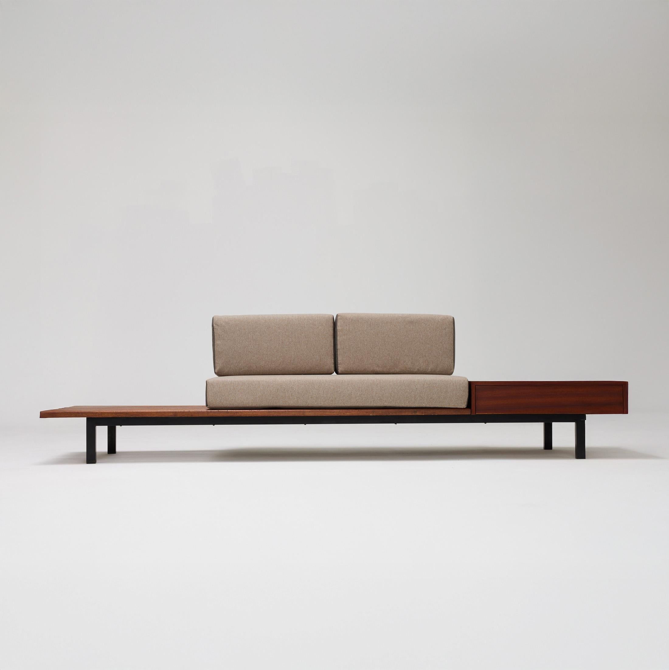 Bench with side table and drawer, from Cite Cansado, Mauritania, designed by Charlotte Perriand.
wood, plastic laminated covered wood, lacquered metal and fabric.

In good original condition, with minor wear consistent with age and use, preserving a