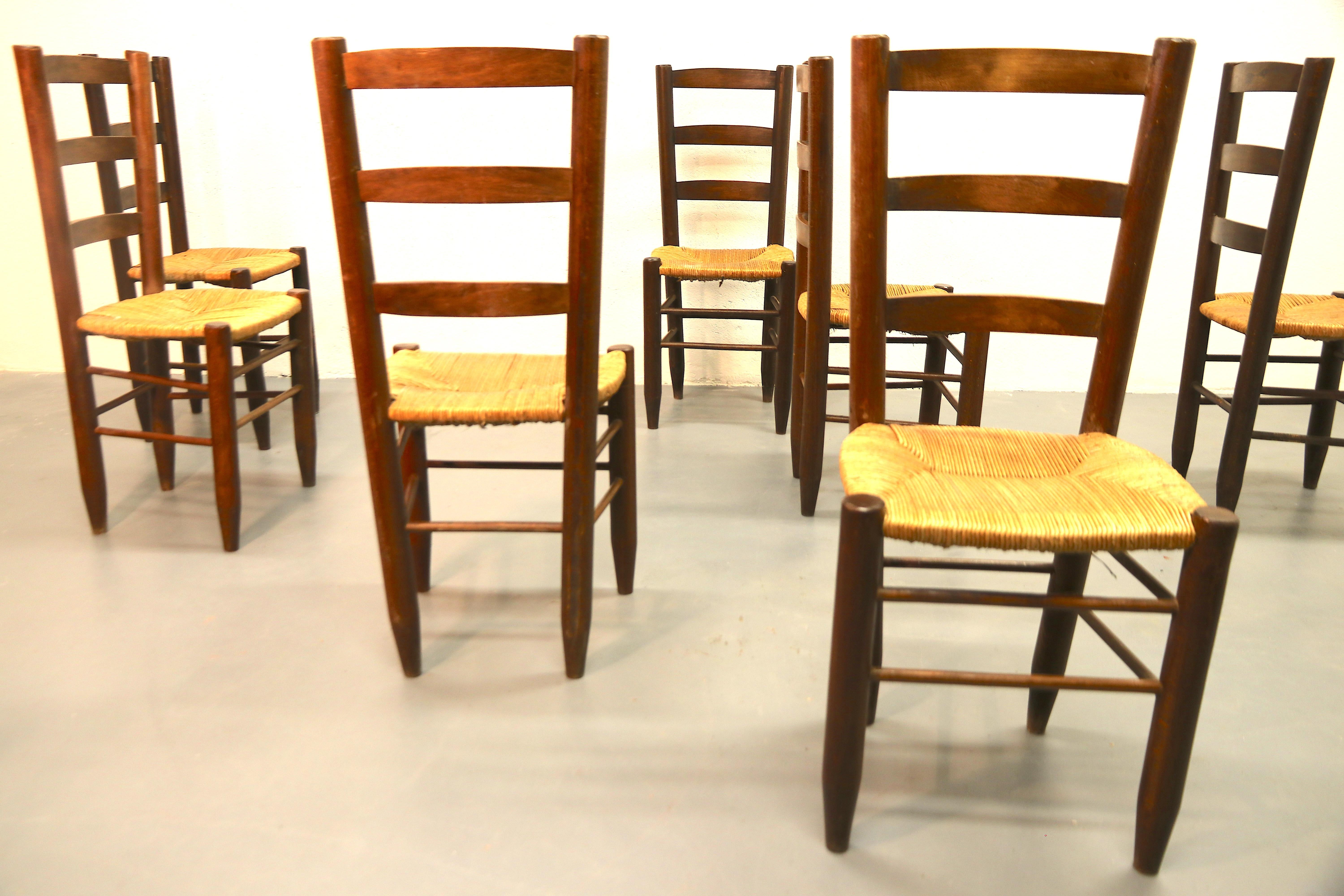 Rare set of eight 1950's solid wood with a rush seat dining room chairs model No. 19 by Charlotte Perriand. The rush is still in very good condition and the frames of the chairs have a beautiful patina. There are (probably) 4 more available, on