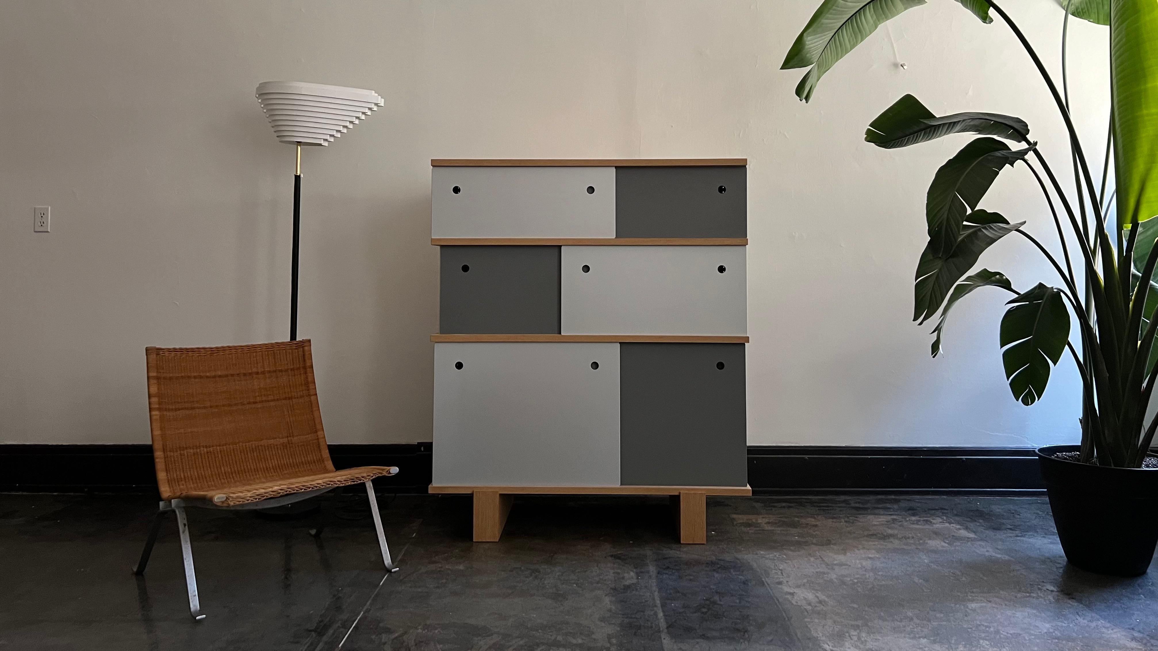The Nuage BL implements Charlotte Perriand's system of modularity into a bookcase. Simple at its core, the Nuage BL consists of individual vertical metal components and oak horizontal components, connected by threaded rods at the corders of the