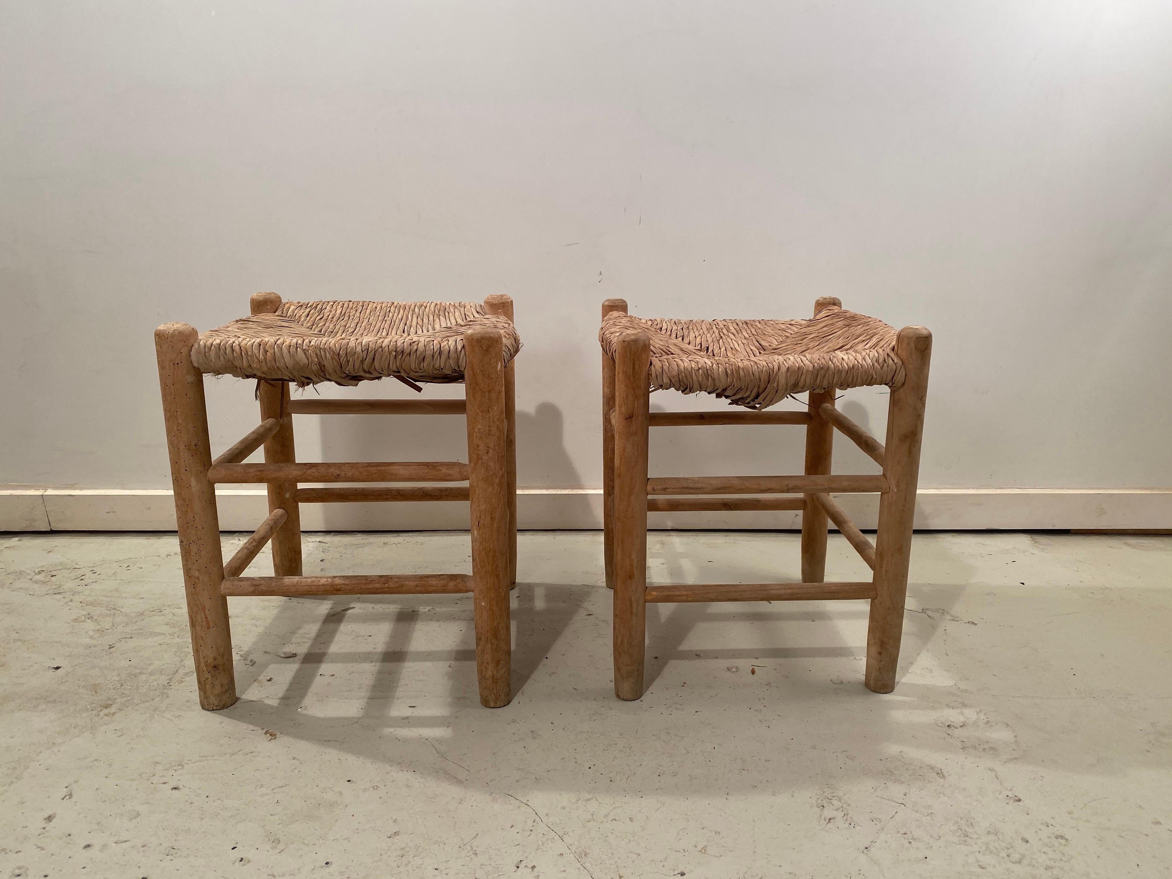 Beautiful pair of wicker Dordogne Charlotte Perriand side stools for Sentou. The wicker is in good condition and the ash wood frame of the stools have the characteristic for Charlotte Perriand pale matt finish.