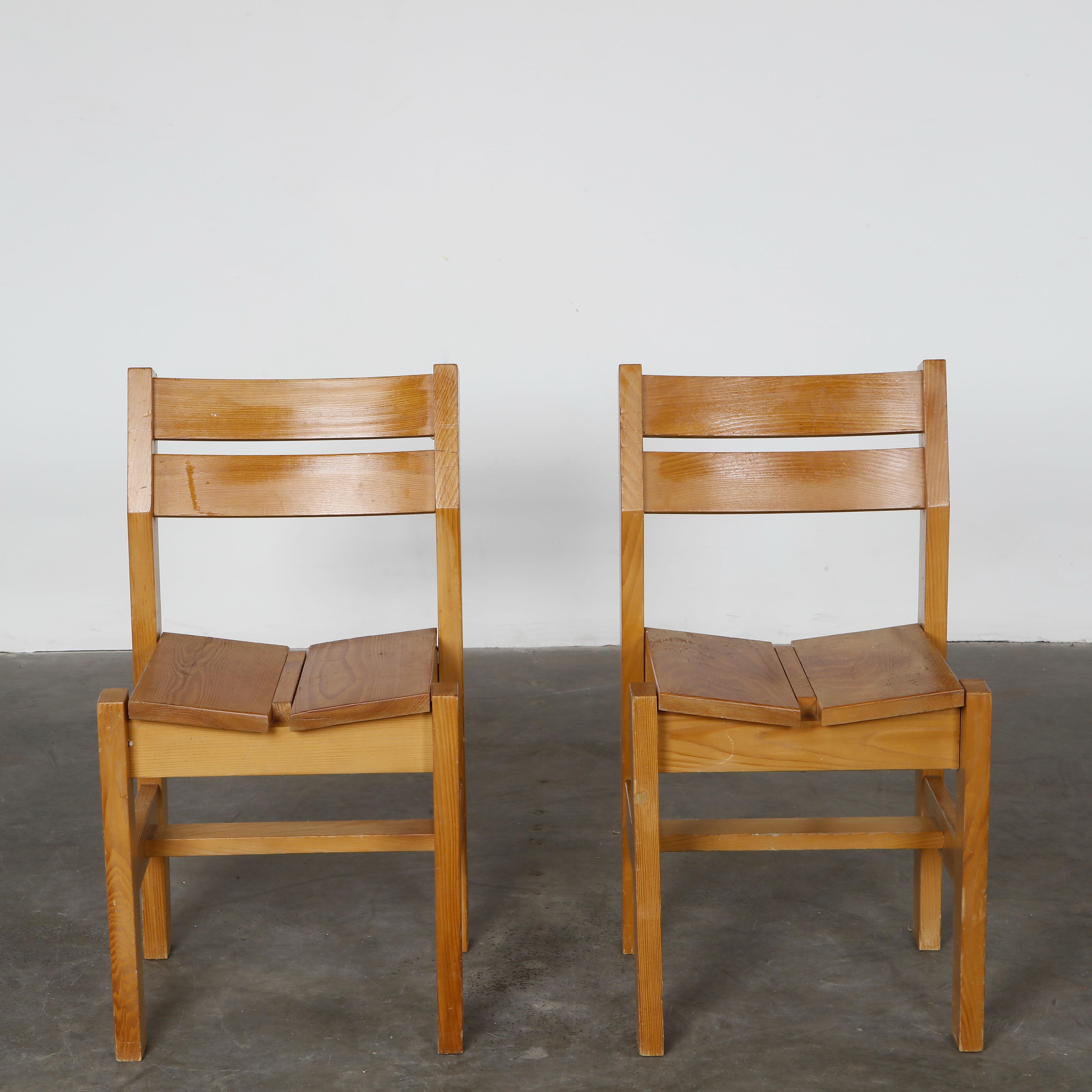Pair of solid pine chairs with clean, angular lines and slatted backs, emblematic of Les Arcs alpine design. Height: 30 in. Width: 16.8 in. Depth: 16 in. Seat Depth: 15 in. Seat Height: 18 in.
